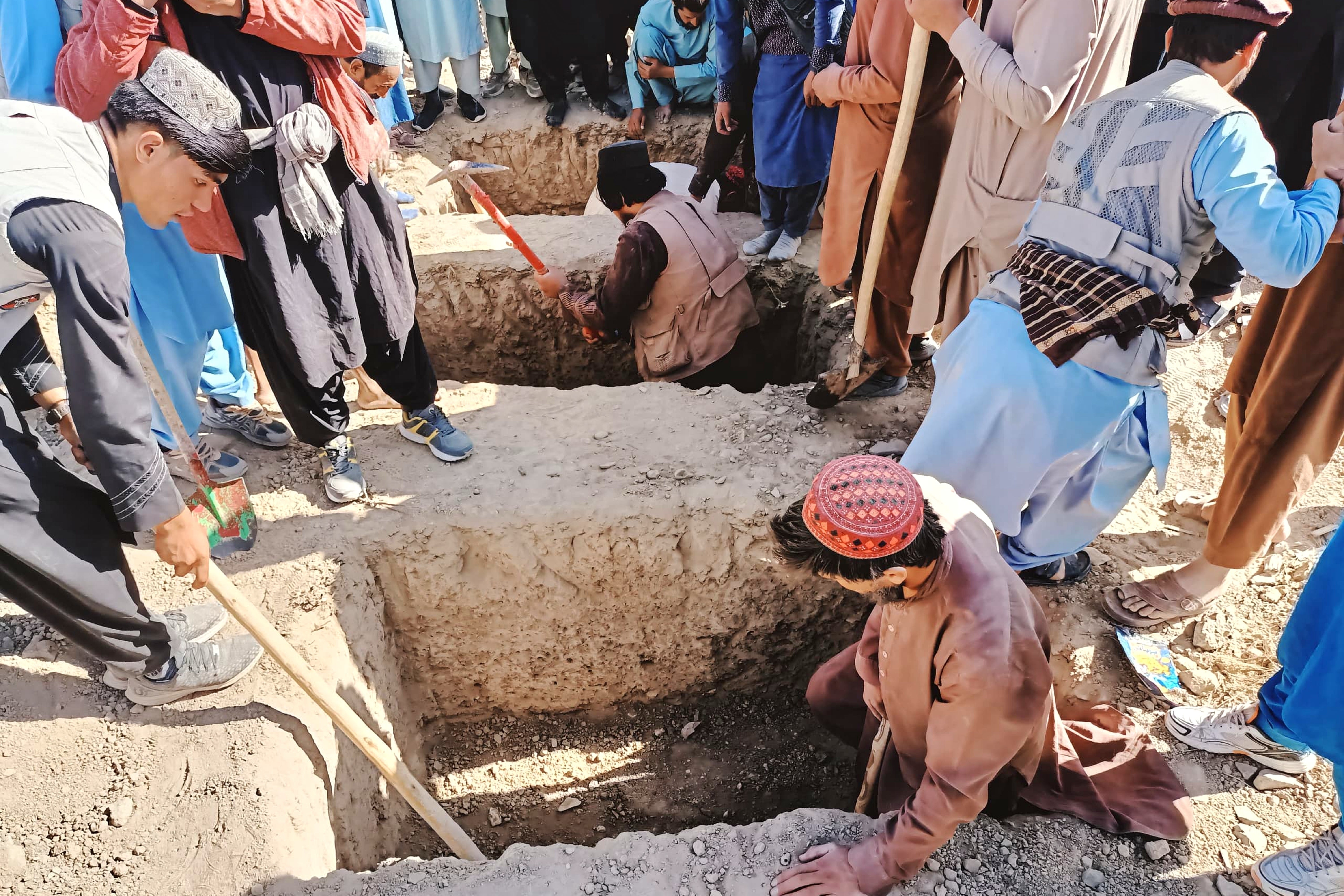 <p>Residents dig graves for those killed in a cross-border airstrike by the Pakistani army in Paktika province, eastern Afghanistan</p>