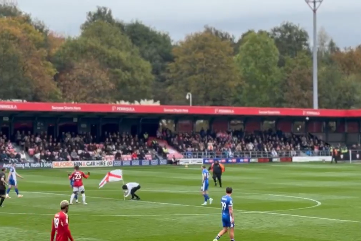 Salford game disrupted by pitch invaders with England flags in protest to Gary Neville Salford game disrupted by pitch invaders with England flags in protest to Gary Neville