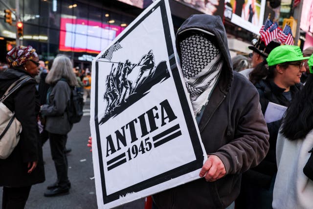 <p>A demonstrator holds an "antifa" placard at a "No Kings" protest against U.S. President Donald Trump's policies, in Times Square in New York City, U.S., October 18, 2025</p>