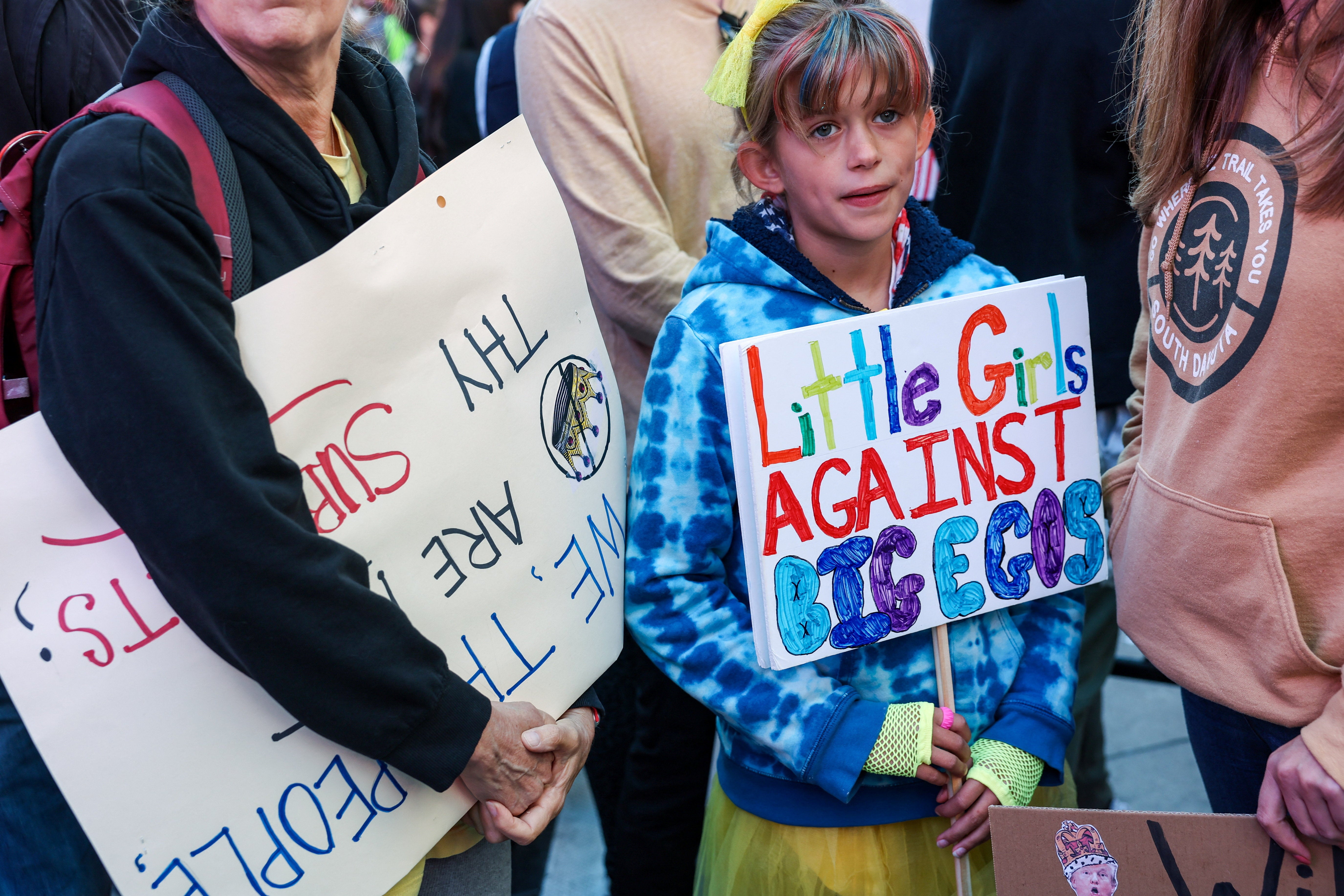 A girl holds a placard in Times Square, in New York