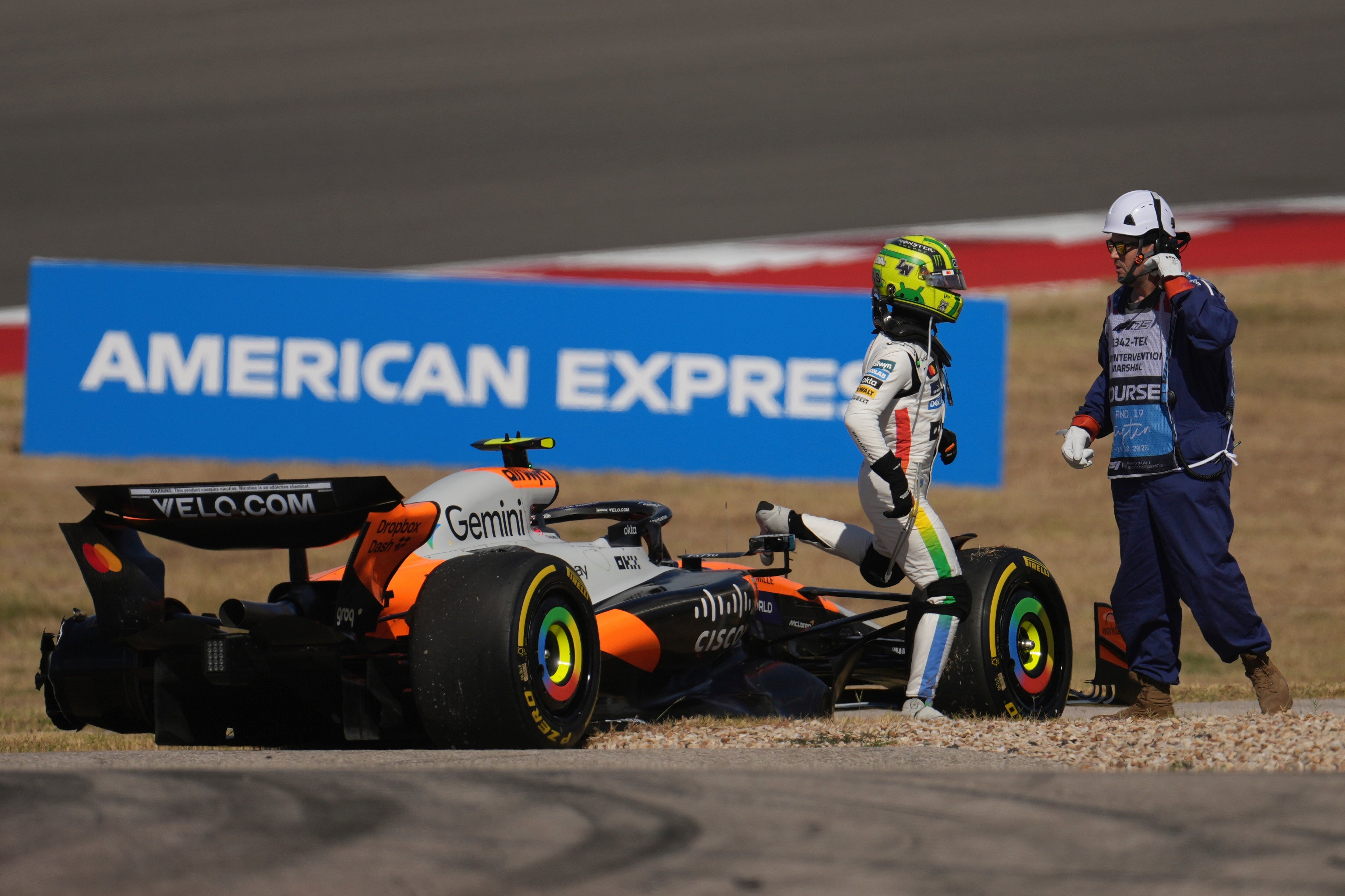 Norris walks away from his stricken car (AP Photo/Eric Gay)