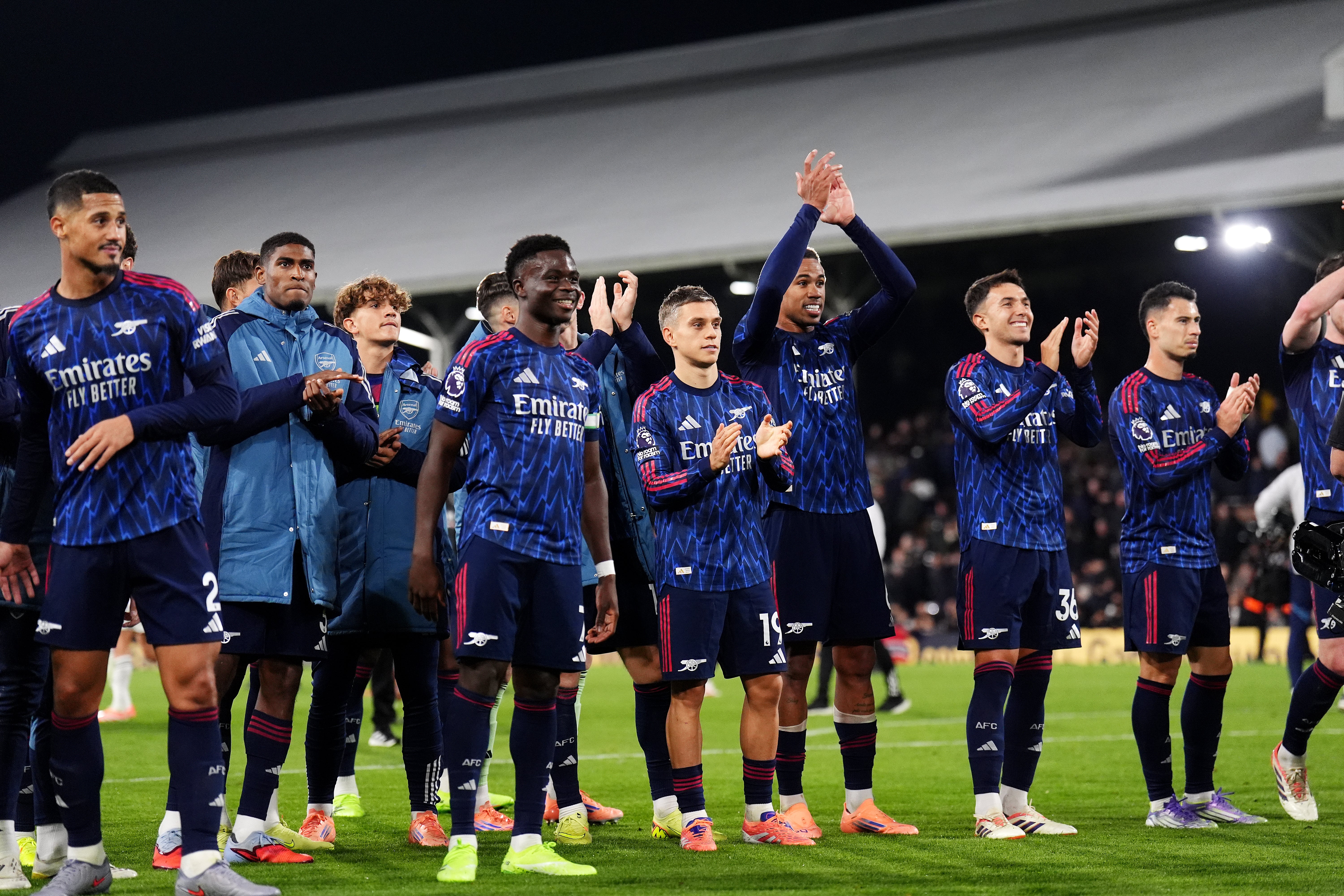 Arsenal players celebrate their hard-fought win at full-time (John Walton/PA)