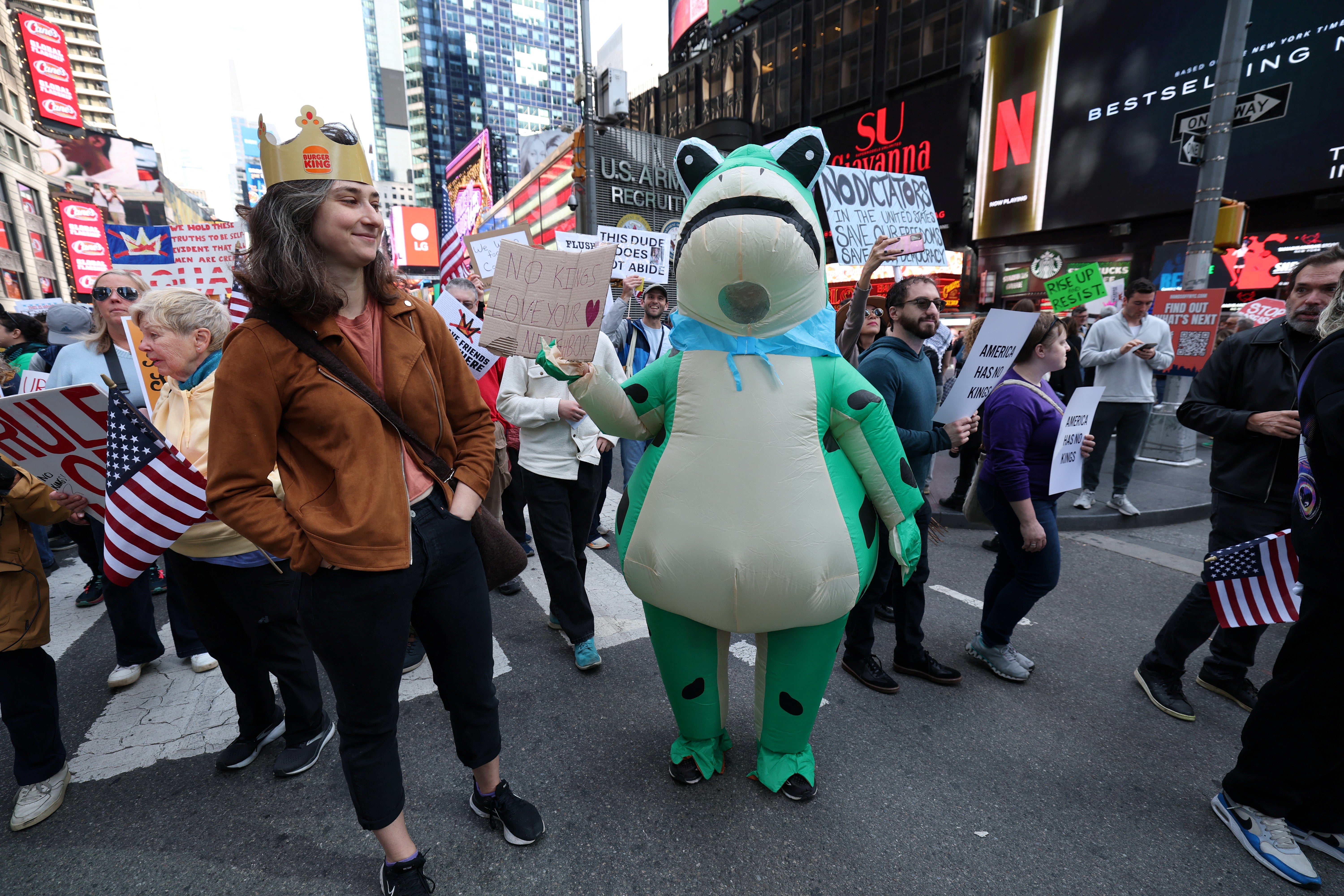 Protesters in New York City show up in a Burger King-branded crown and inflatable frog costumes in Times Square