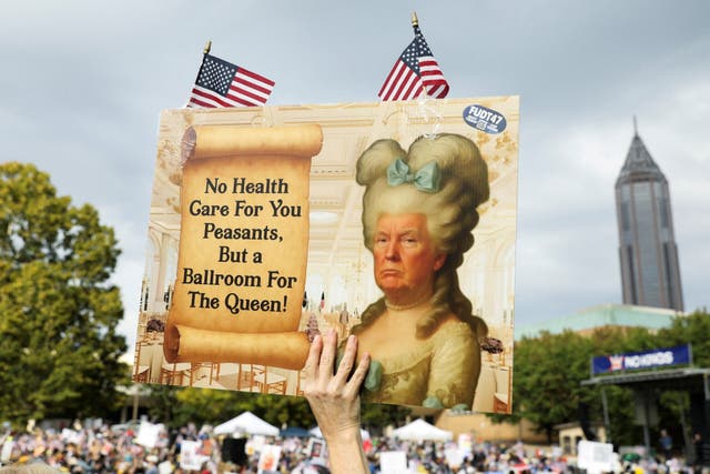 <p>A person holds a placard with an image depicting U.S. President Donald Trump as a queen, on the day of a "No Kings" protest against U.S. President Donald Trump's policies, in Atlanta, Georgia, U.S., October 18, 2025. REUTERS/Alyssa Pointer</p>