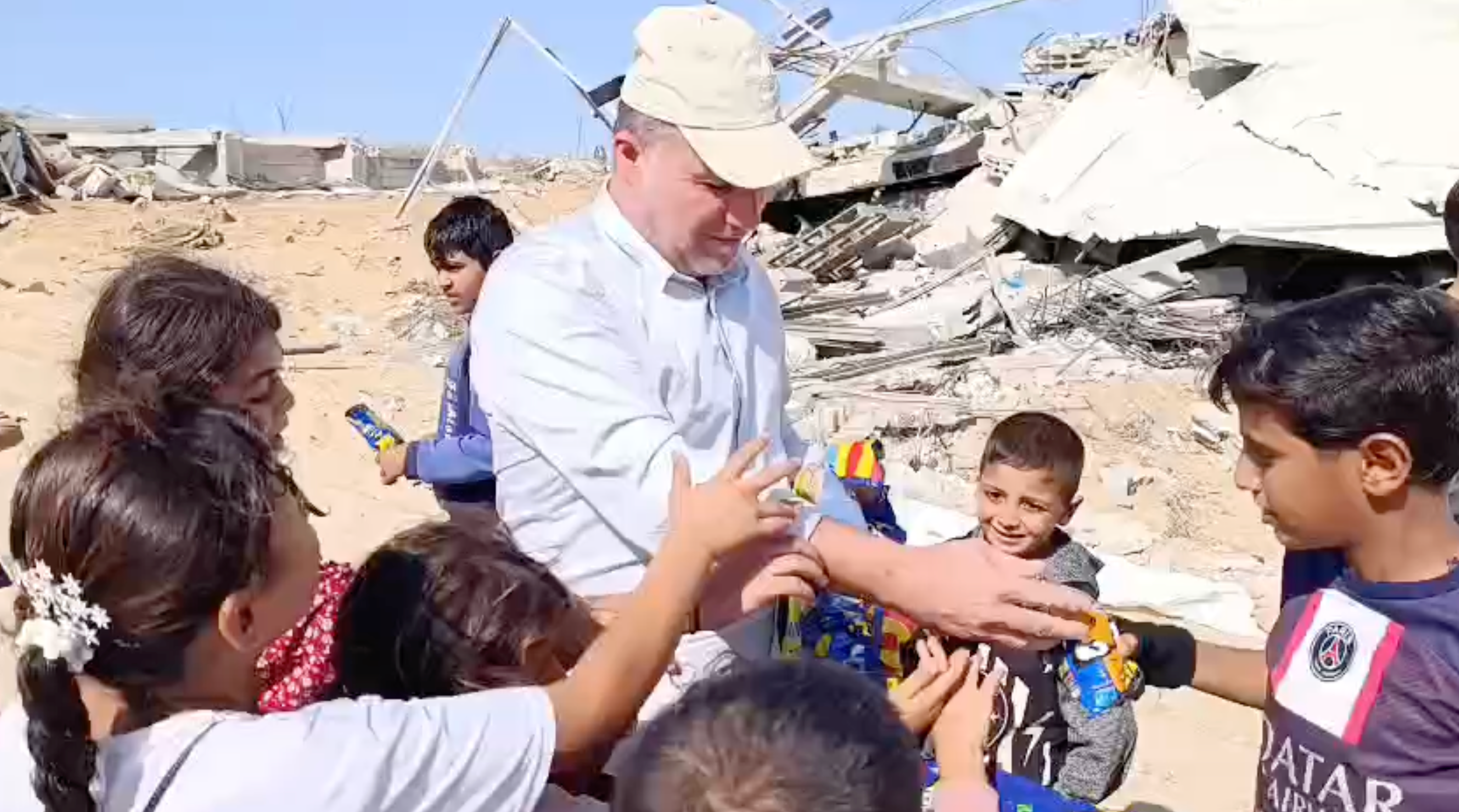 Hossam al-Astal, head of an anti-Hamas armed faction, sends a video of him handing out sweets to children east of Khan Younis behind Isarel’s withdrawl line