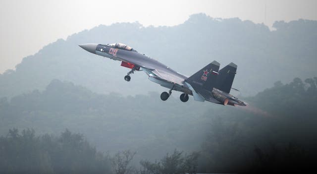 File. A Sukhoi SU-35 fighter jet takes off during a test flight ahead of the Airshow China 2014 in Zhuhai, South China's Guangdong province, in 2014. - Australia said the PLA used a Su-35 fighter jet to deploy flares near an Australian surveillance plane