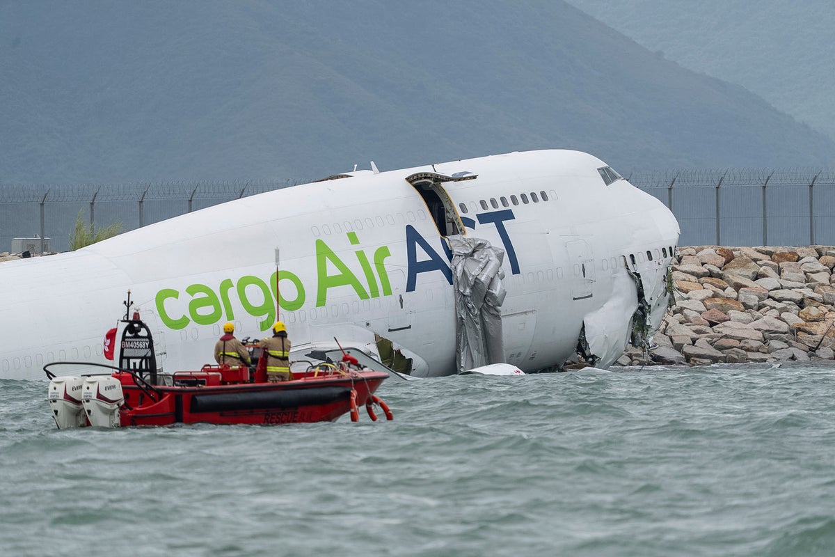 Two dead as Hong Kong cargo plane splits in half after skidding off runway and slamming into ground vehicle