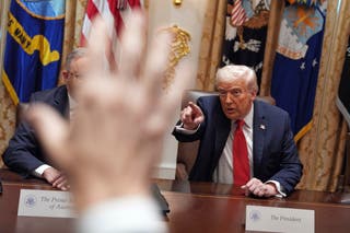 President Donald Trump points as reporters raise their hands to ask questions during a meeting in the Cabinet Room of the White House