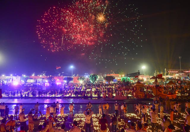 <p>Locals watch a firework show on the banks of the Saryu River on 19 October, the eve of Diwali festival, in Ayodhya, northern India</p>