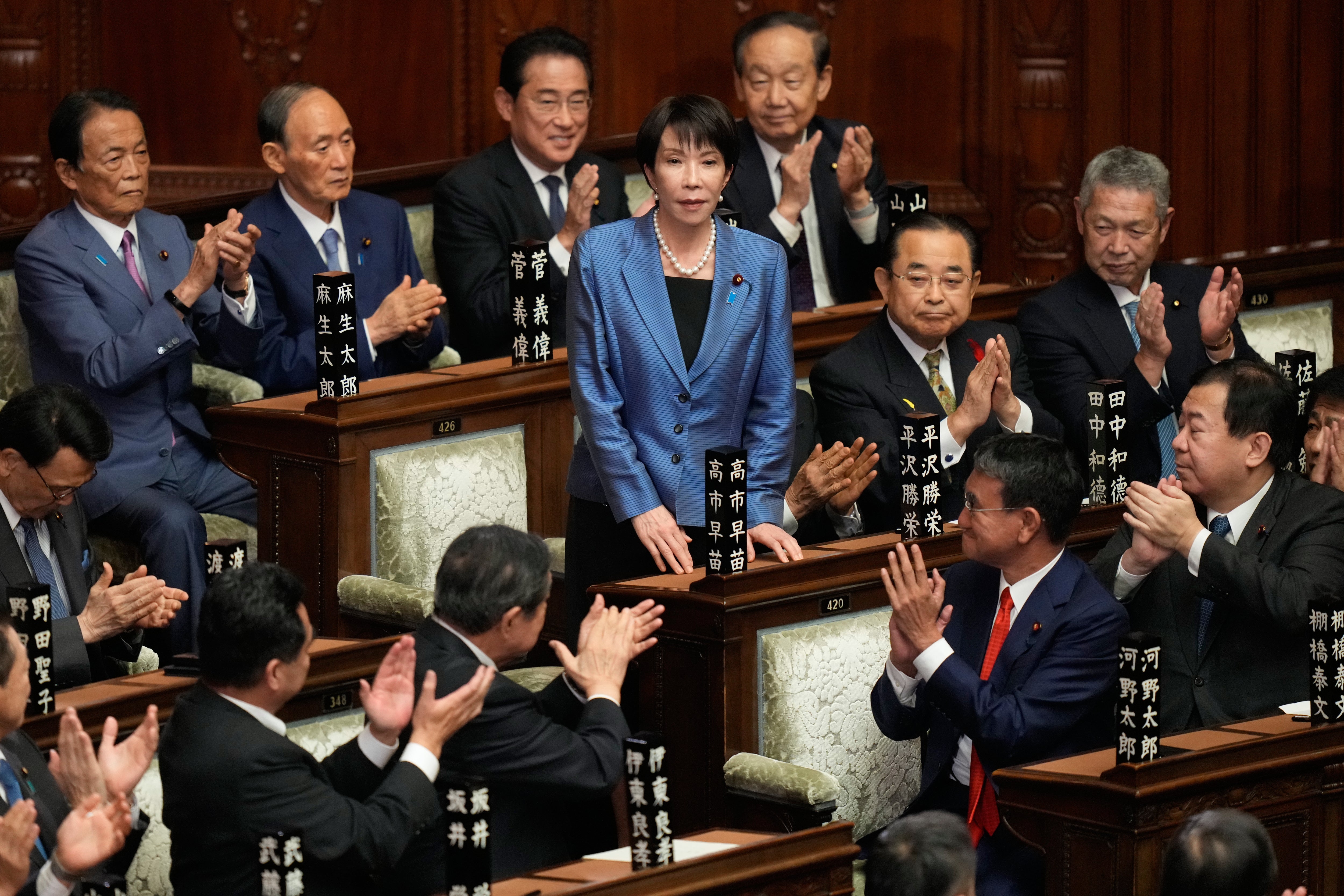 Lawmakers applaud as Sanae Takaichi (centre) is elected as Japan’s new prime minister during the extraordinary session of the lower house, in Tokyo