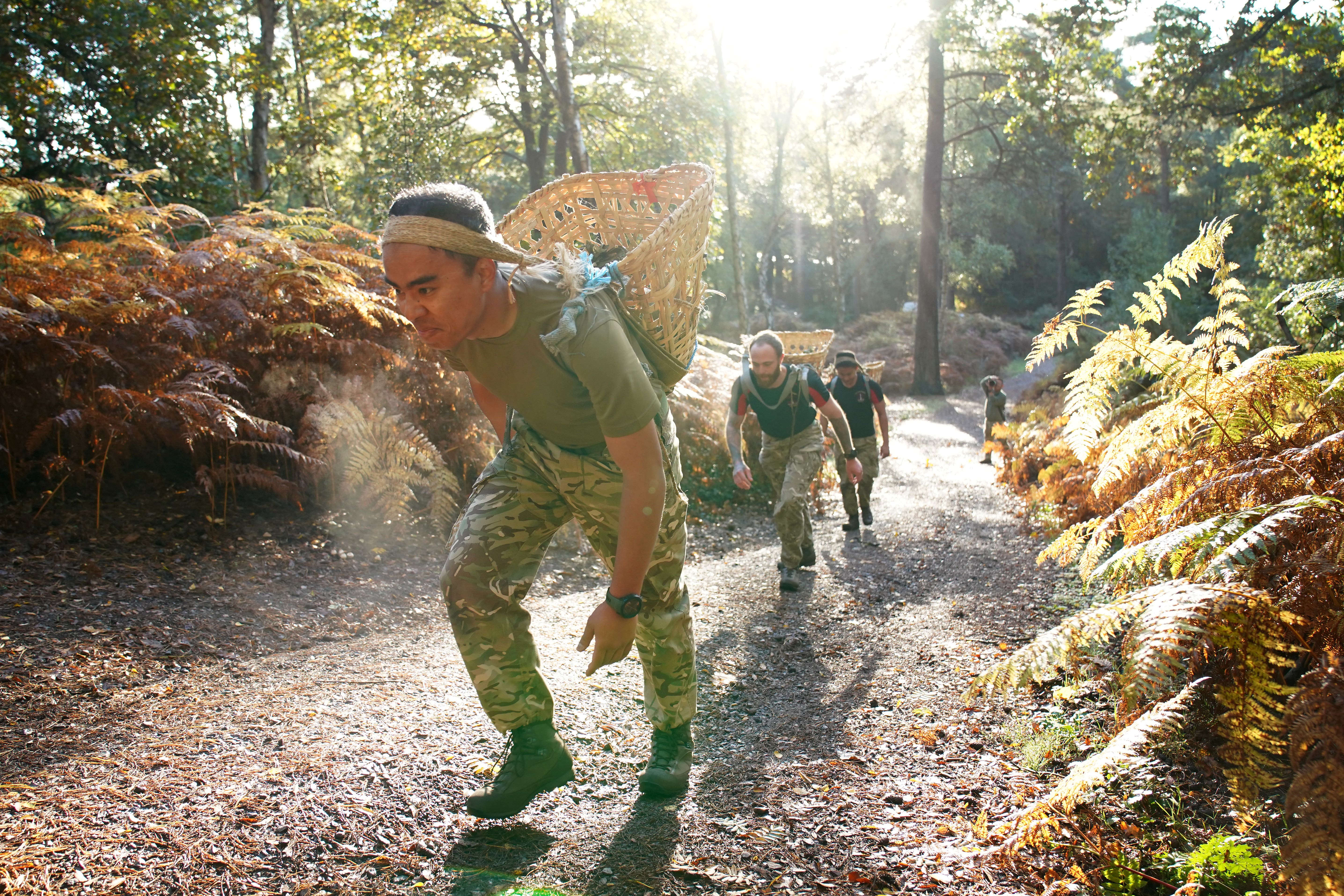 Members of the military take part in the tri-service Gurkha Doko race, carrying a Doko, a traditional Nepalese bamboo basket, weighing 15kg over five kilometres, at the Army Training Centre in Pirbright, Surrey. The Doko race was introduced in 1989 and is regarded as a rite of passage that all Gurkhas must go through to be selected for the British Army’s Brigade of Gurkhas. Picture date: Tuesday October 21, 2025.