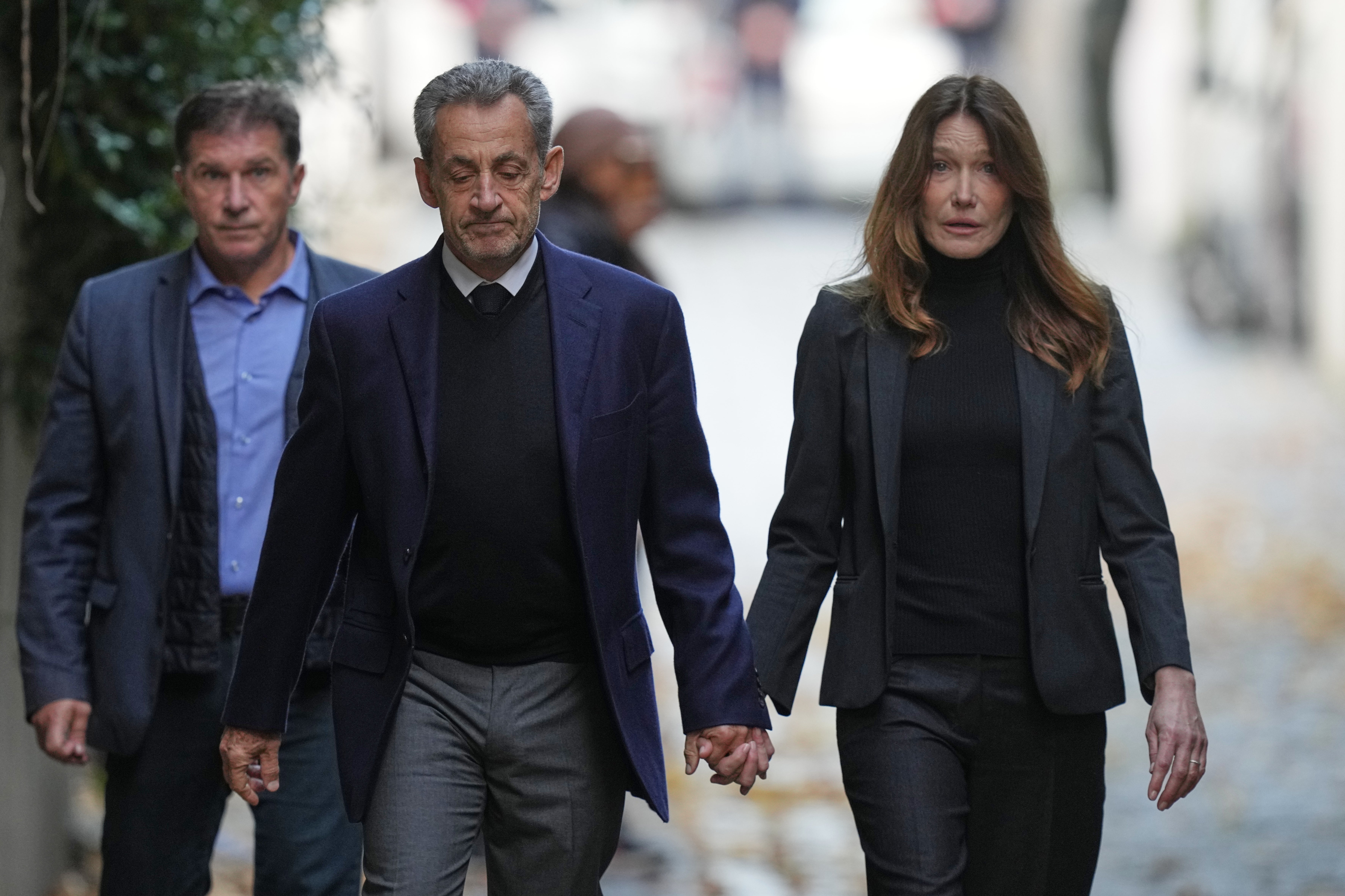 Nicolas Sarkozy and his wife, Carla Bruni, leave their house before the former president begins his five-year prison sentence on Tuesday 21 October