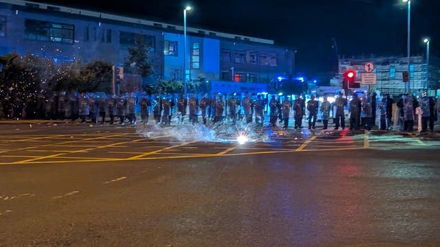 <p>Protesters throw fireworks at gardai officers in Saggart </p>
