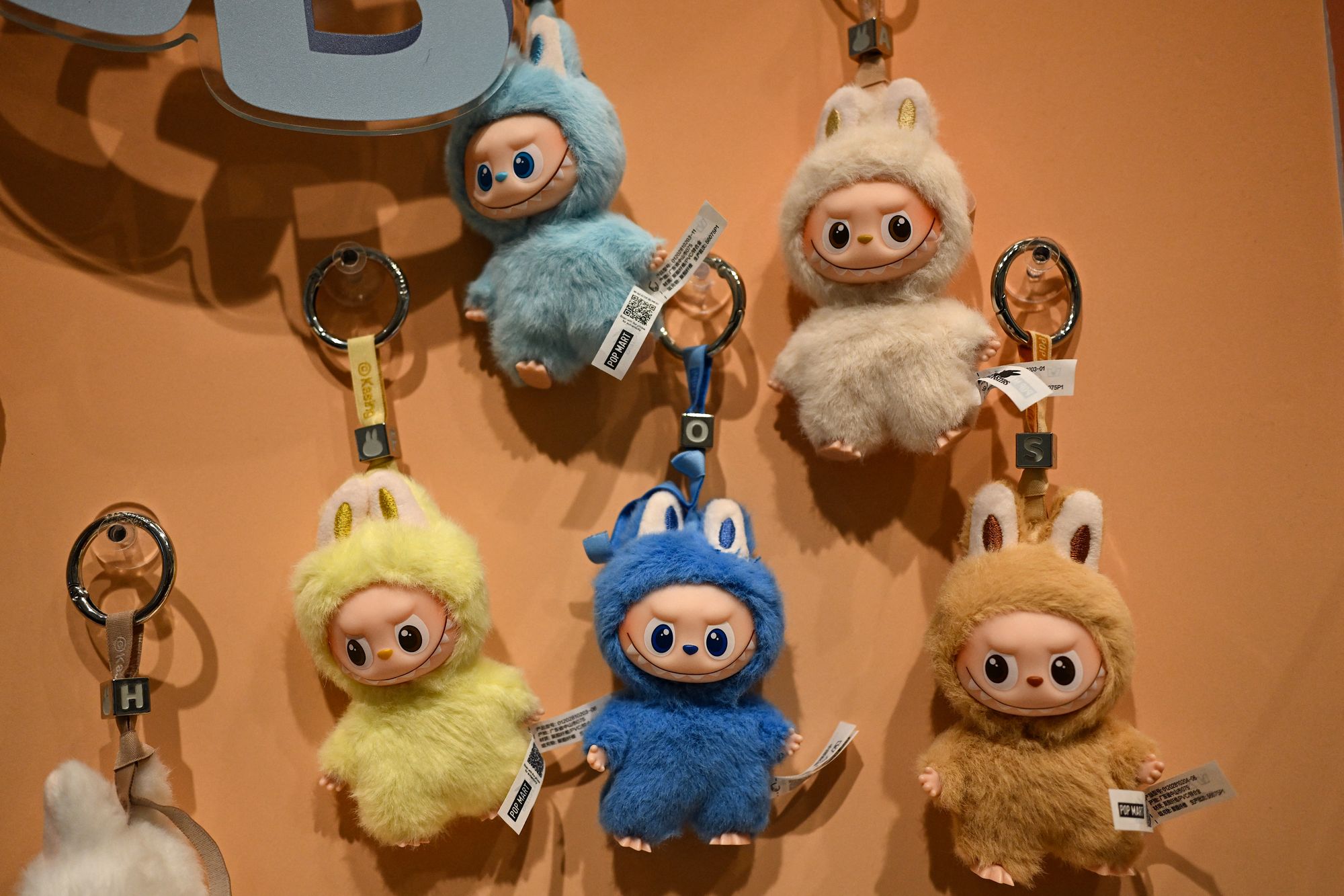 <p>Newly-launched mini Labubu toys are displayed at a Pop Mart shop in Beijing</p>