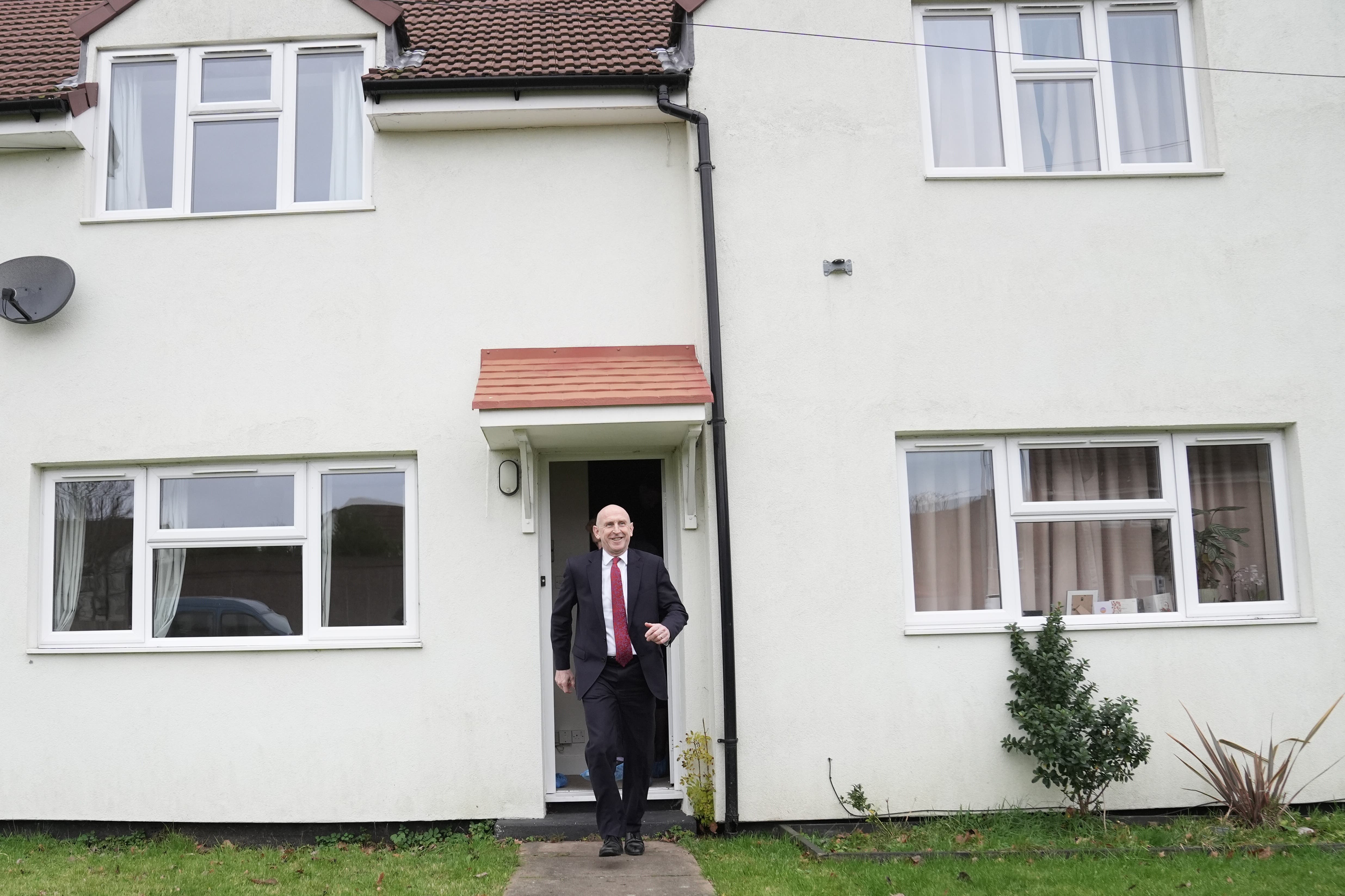 Defence Secretary John Healey leaves a military housing property (Stefan Rousseau/PA)