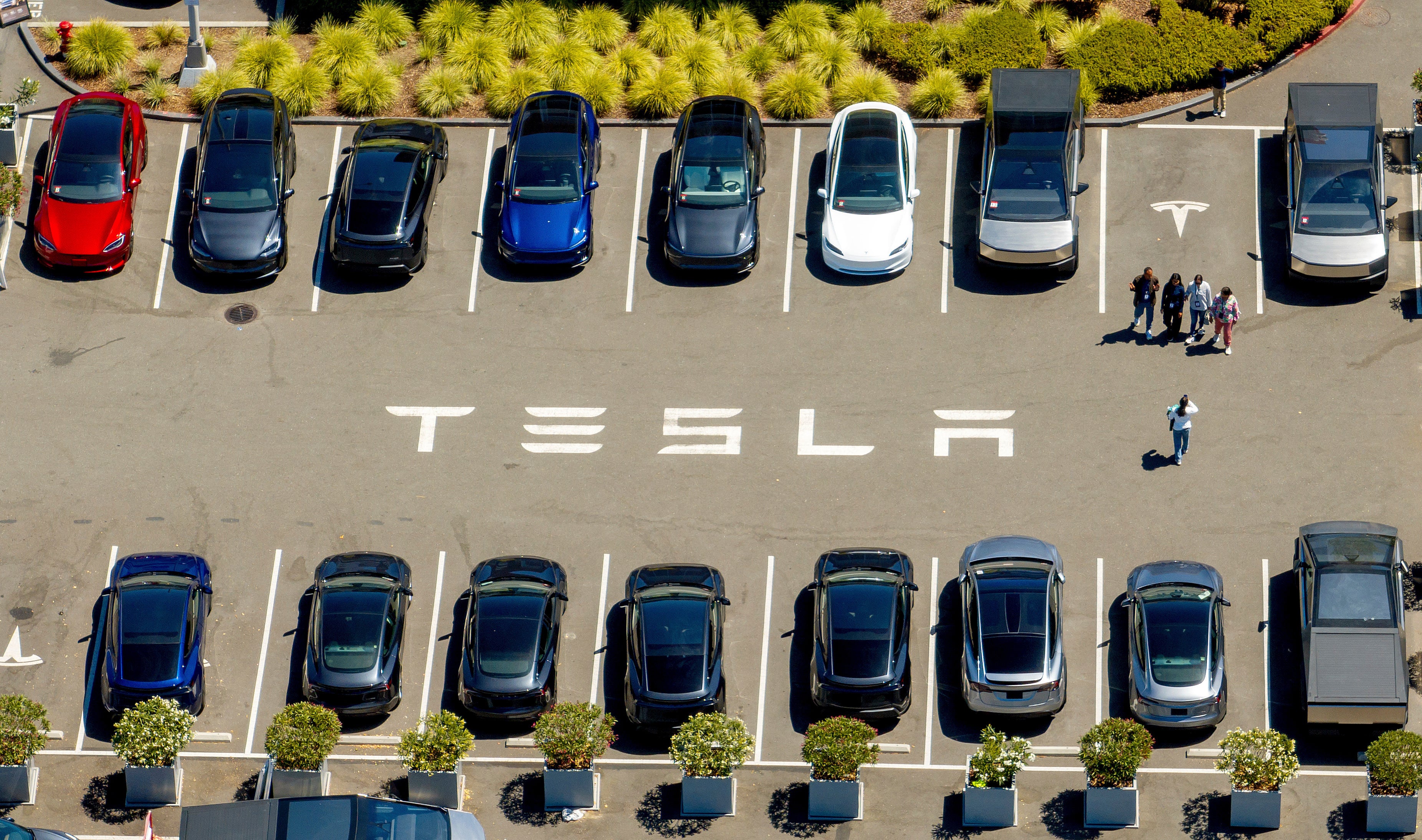 Tesla posted record sales in its third quarter, as consumers raced to make use of an expiring tax credit
