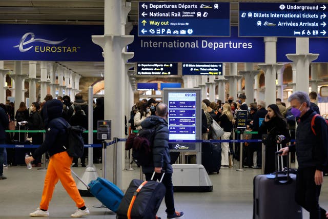 <p>Eurostar passengers and holidaymakers queue to access French border controls on the British side at start of the summer holiday weekend</p>