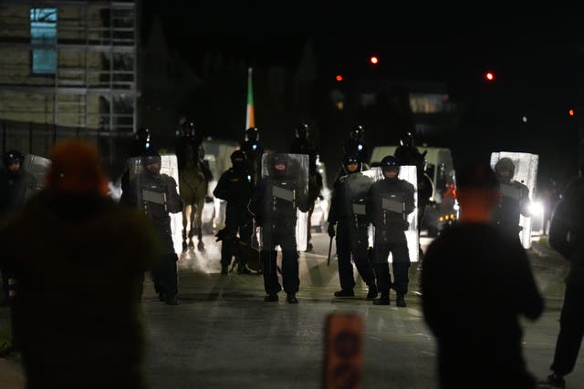 Gardai officers block protesters near the Citywest Hotel, as disturbances have flared outside the Dublin hotel which used to house asylum seekers (Niall Carson/PA)