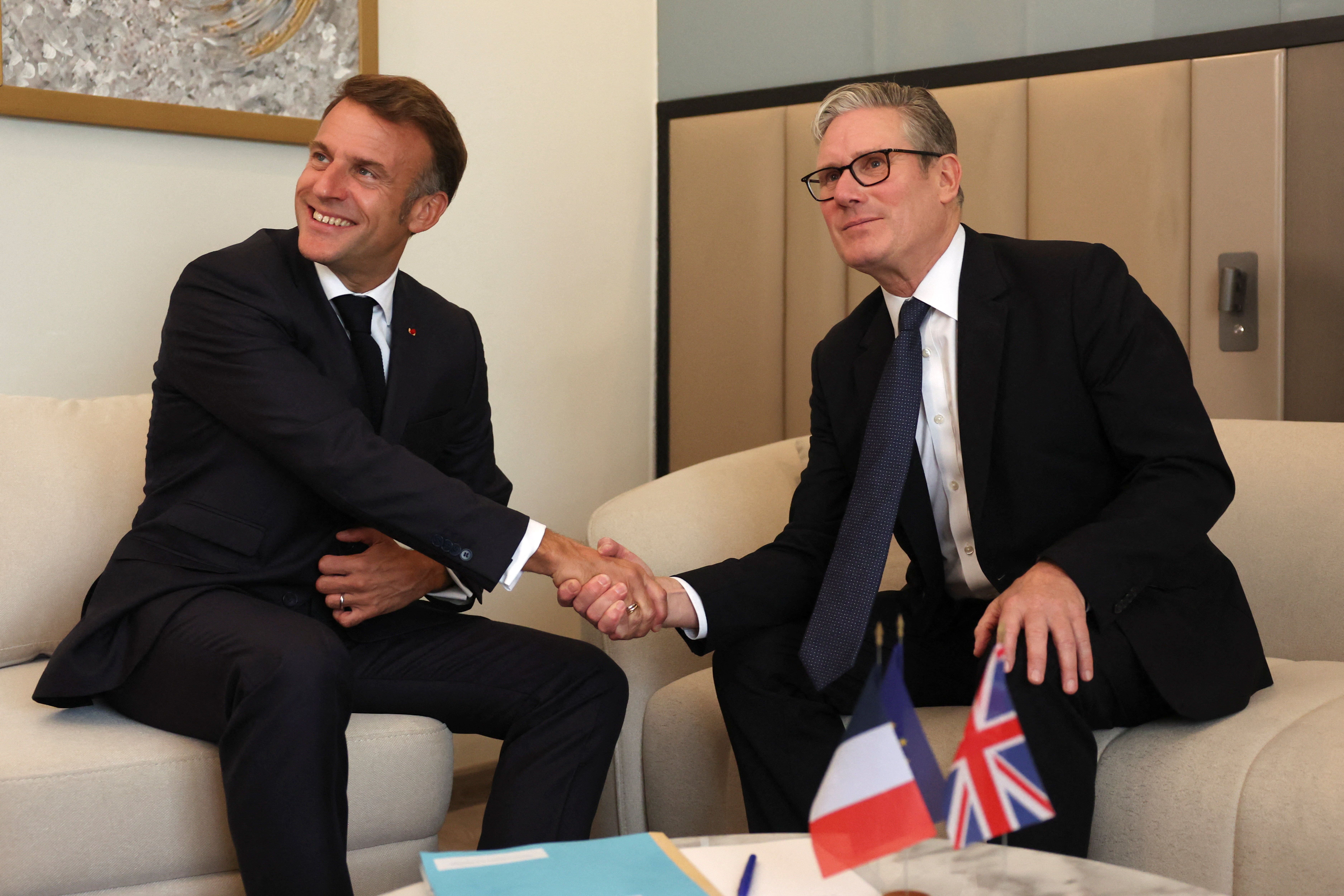 Sir Keir Starmer and Emmanuel Macron struck a deal on migration earlier this year, but crossings continue and a planned change to French rules has yet to be implemented (Suzanne Plunkett/PA)
