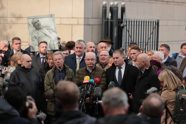 The brothers of Bloody Sunday victim William McKinney, Joe (second left), Mickey (third left), and John (right), speak to the media outside Belfast Crown Court alongside solicitor Ciaran Shiels (second right) (Liam McBurney/PA)