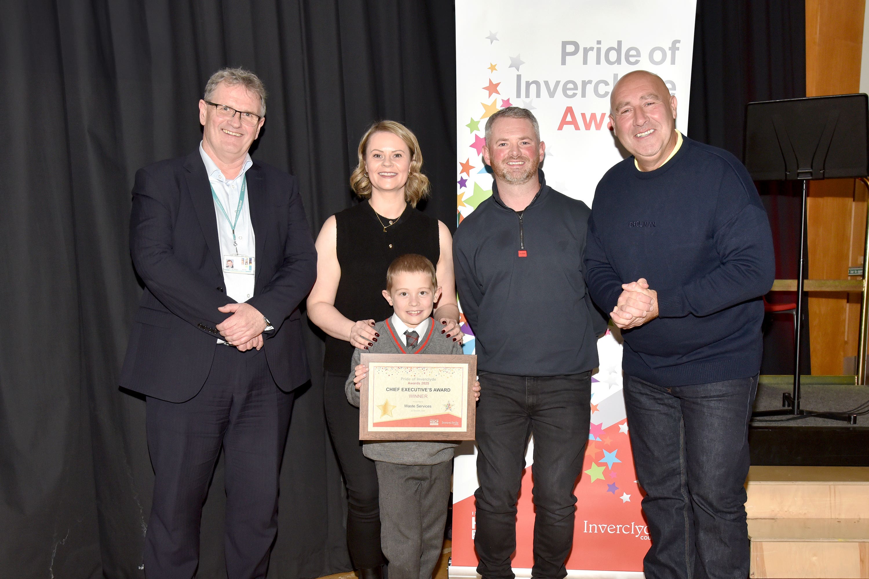 David Millar and Brian Copeland were presented with the award by their young friend Jaxx (Inverclyde Council/PA)
