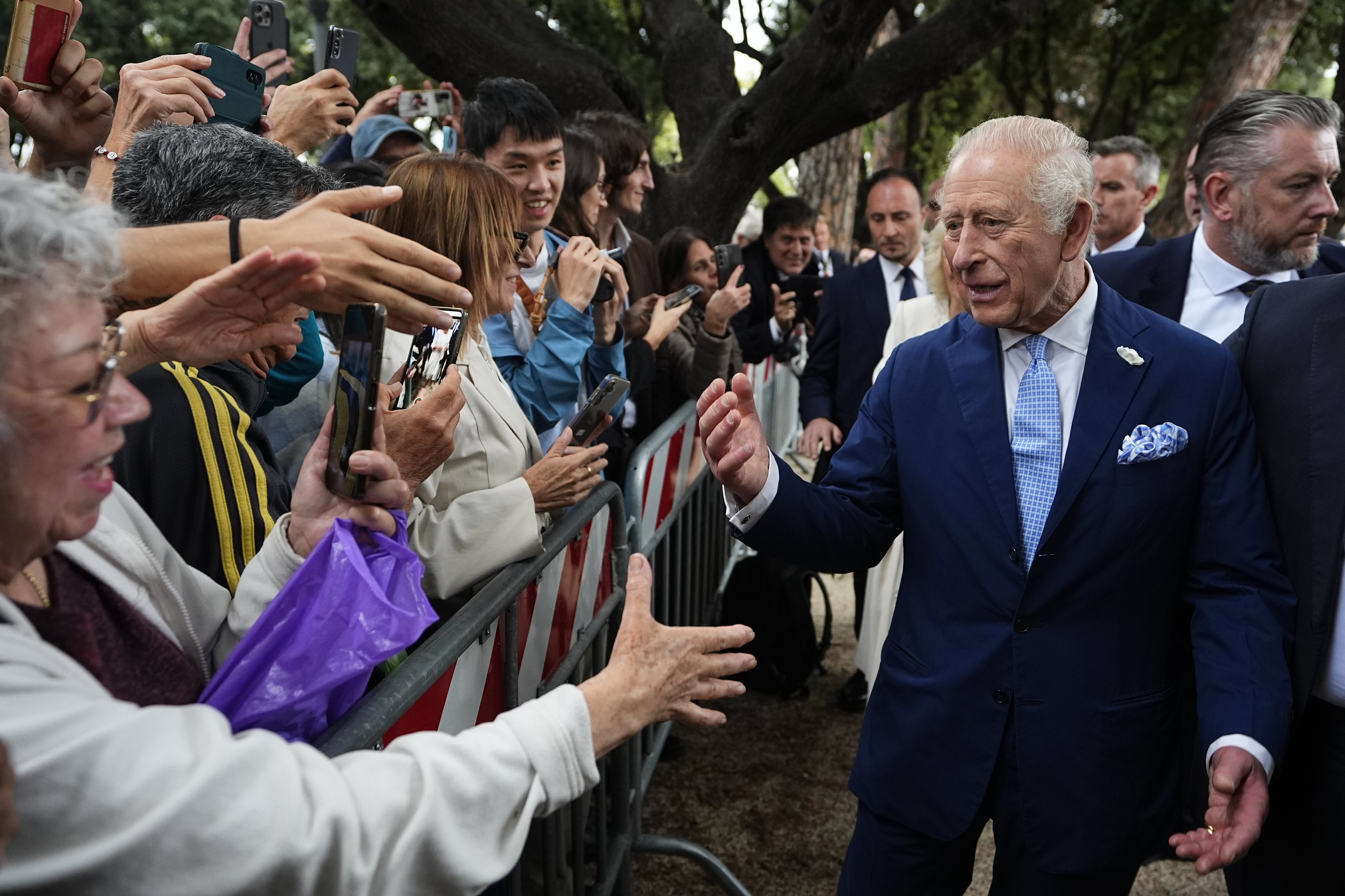 King Charles III, by far the richest British sovereign in modern times, meets members of the public outside the Papal Basilica