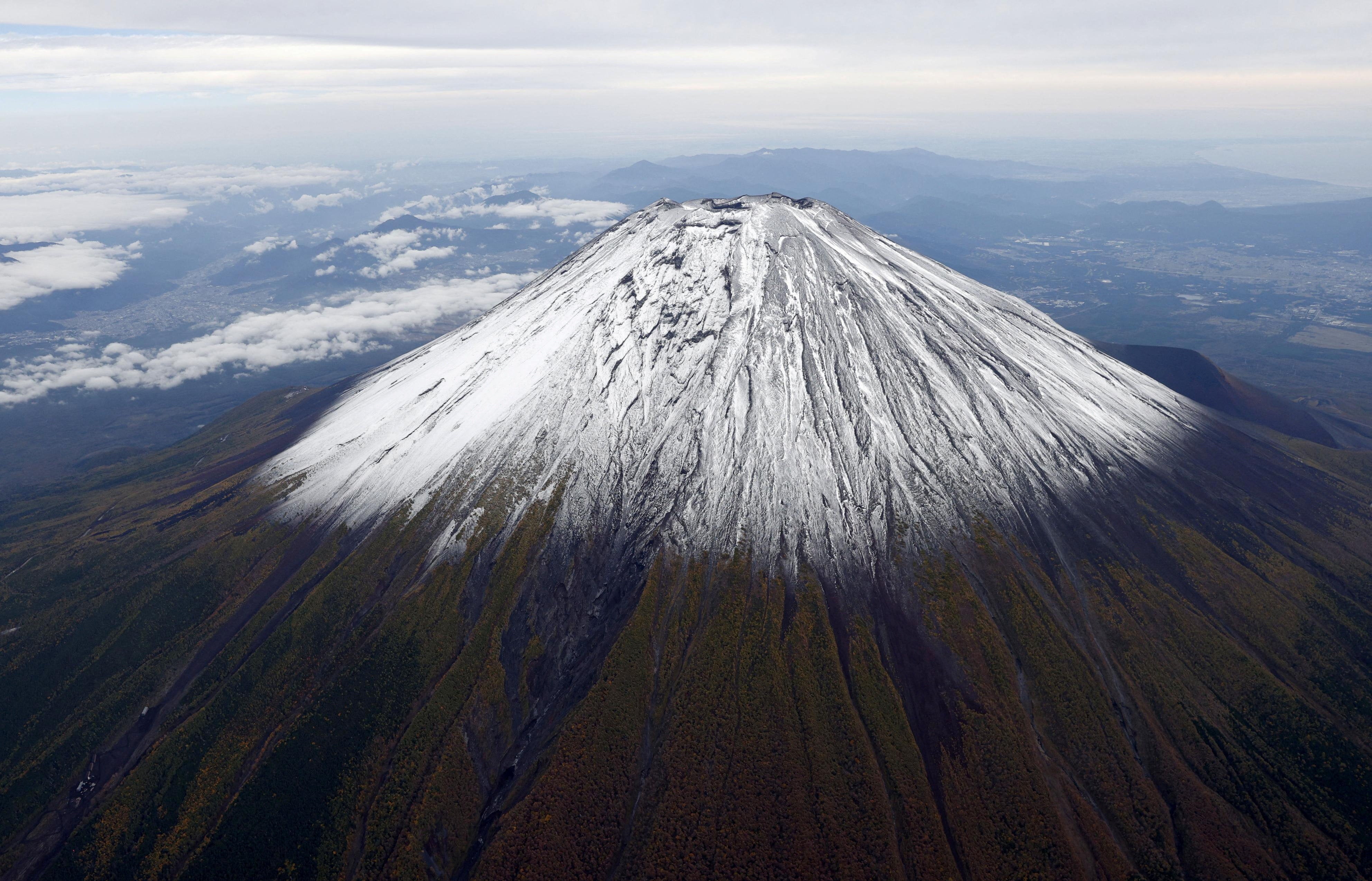 A photo taken from a helicopter shows the season’s first snowcap on Mount Fuji on 23 October 2025
