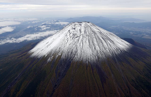 <p>Photo taken from a helicopter shows the season’s first snowcap on Mount Fuji, Japan’s highest mountain, on 23 October 2025</p>