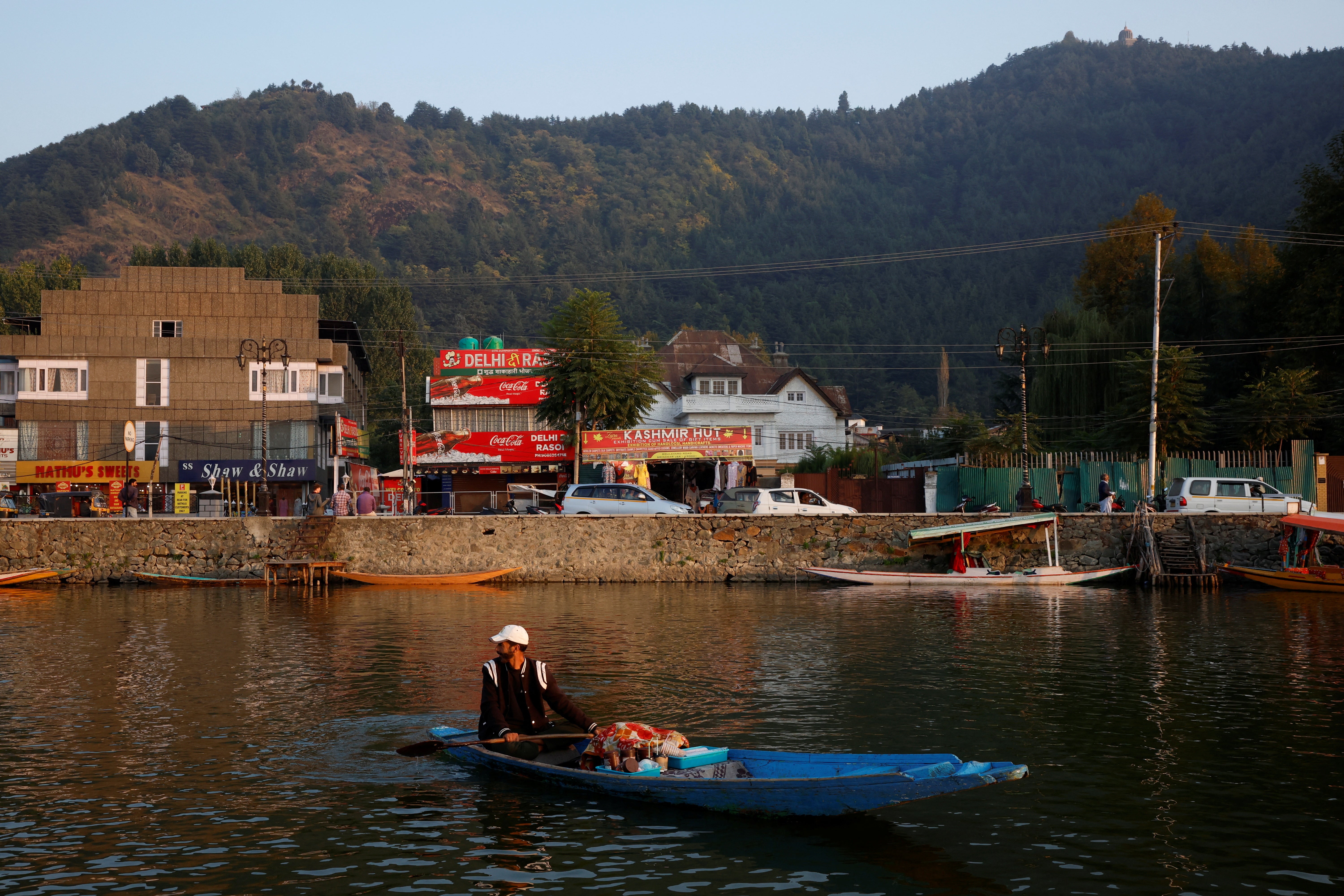 Gulzar Ahmad Bhat, 49, a carpet weaver, looks on as he sells tea while waiting for customers on the waters of Dal Lake in Srinagar, Indian Kashmir