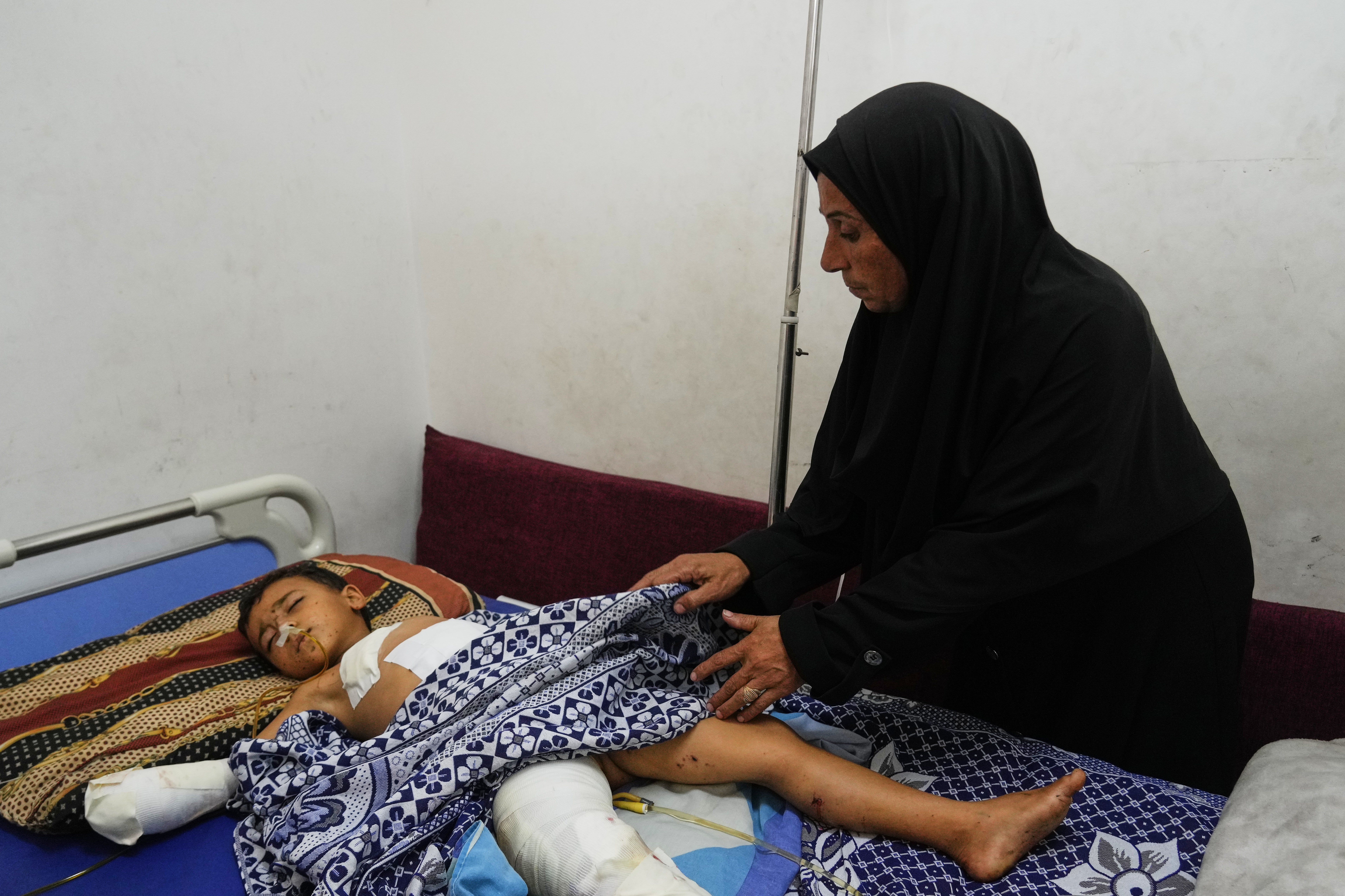 <p>Hanan Shakshk cares her grandson Yahya Shorbasi, who was injured by an unexploded ordnance along with his six-year-old twin sister Nabila, at Shifa Hospital in Gaza City, Saturday, Oct. 25, 2025. (AP Photo/Abdel Kareem Hana)</p>