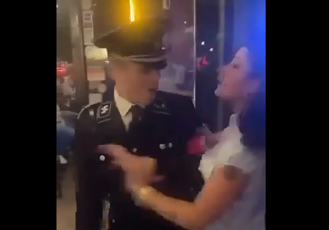 <p>Kenneth Morgan, 33, left, wearing a Nazi uniform and yelling at a woman who is trying to keep him from entering Cutter's Pub in Athens, Georgia </p>