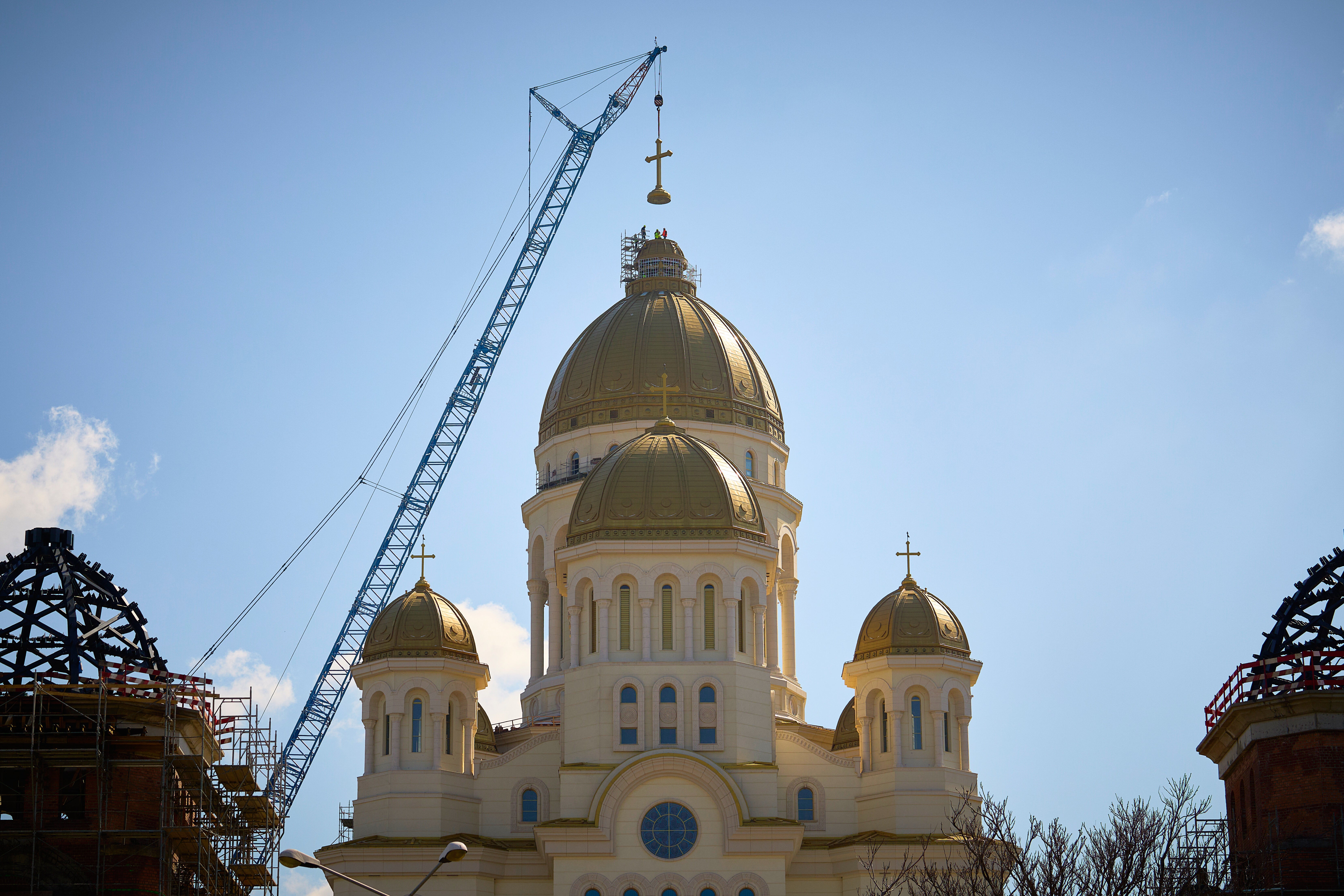 <p>Construction workers install the main cross of the National Cathedral, in Bucharest, Romania, Tuesday, April 8, 2025. (AP Photo/Vadim Ghirda, File)</p>