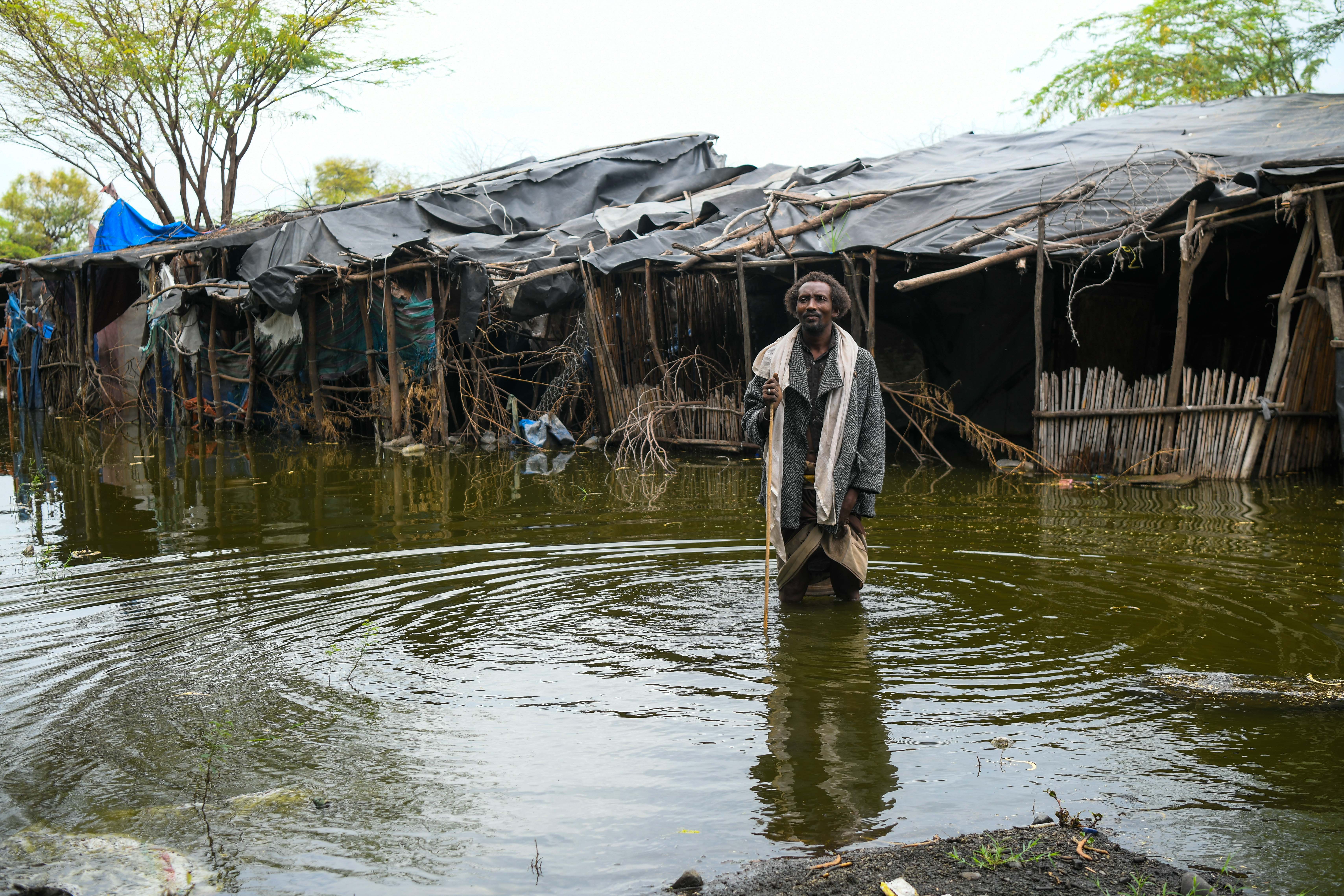 The several hundred households of Kebena are among more than 5,000 households impacted by the flooding. Pictured is 40-year-old Alo Baniya in front of his flooded house