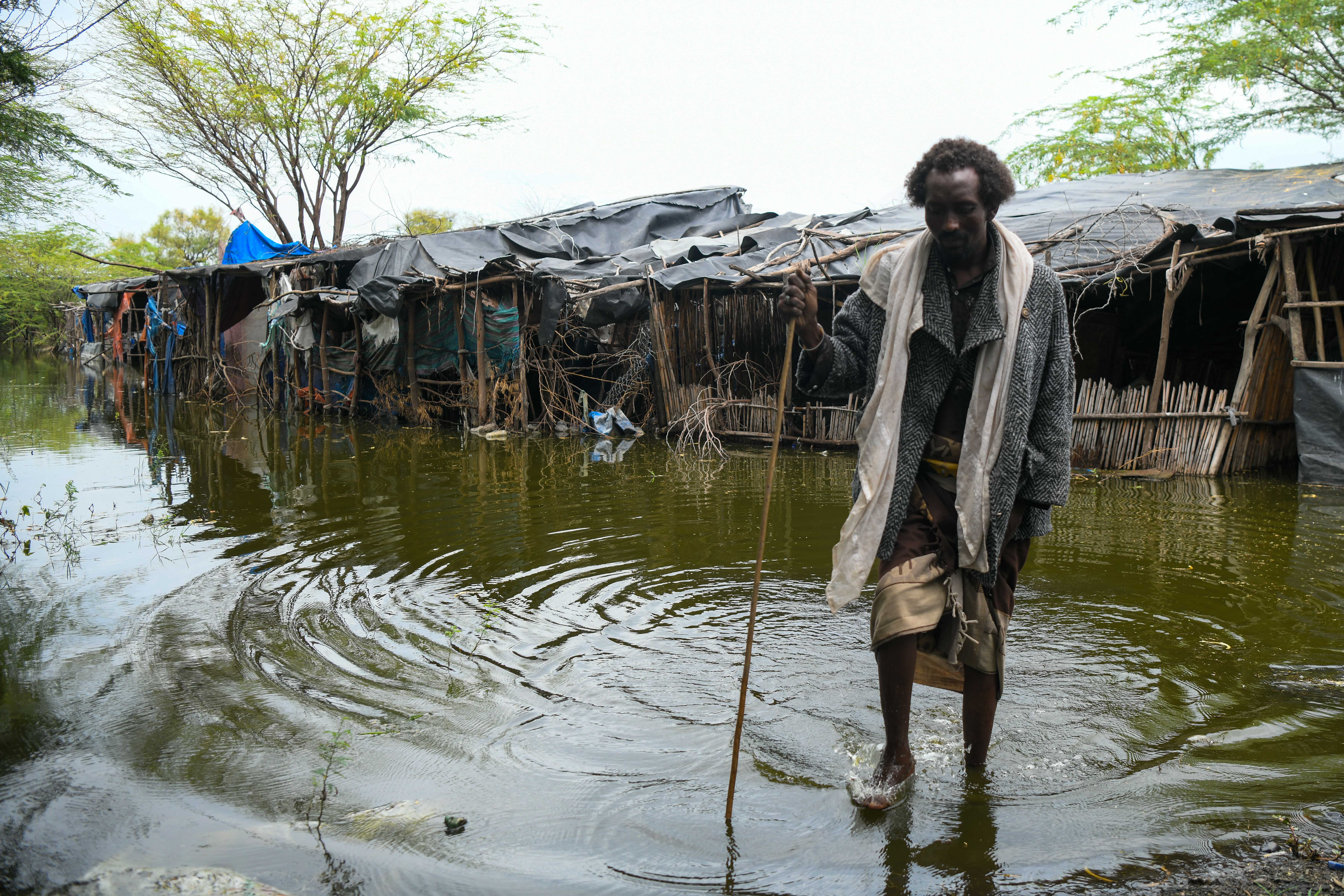 <p>Alo Baniya, 40, a father if seven, shows <em>The Independent</em> around his village, which remained flooded two months after the Awash River burst its banks</p>