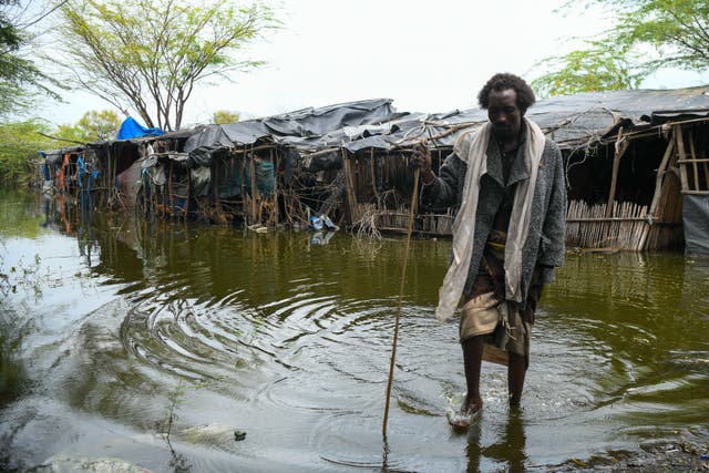 <p>Alo Baniya, 40, a father if seven, shows <em>The Independent</em> around his village, which remained flooded two months after the Awash River burst its banks</p>