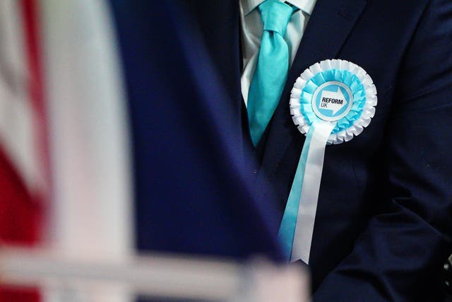 A person wearing a Reform UK rosette (Ben Birchall/PA)