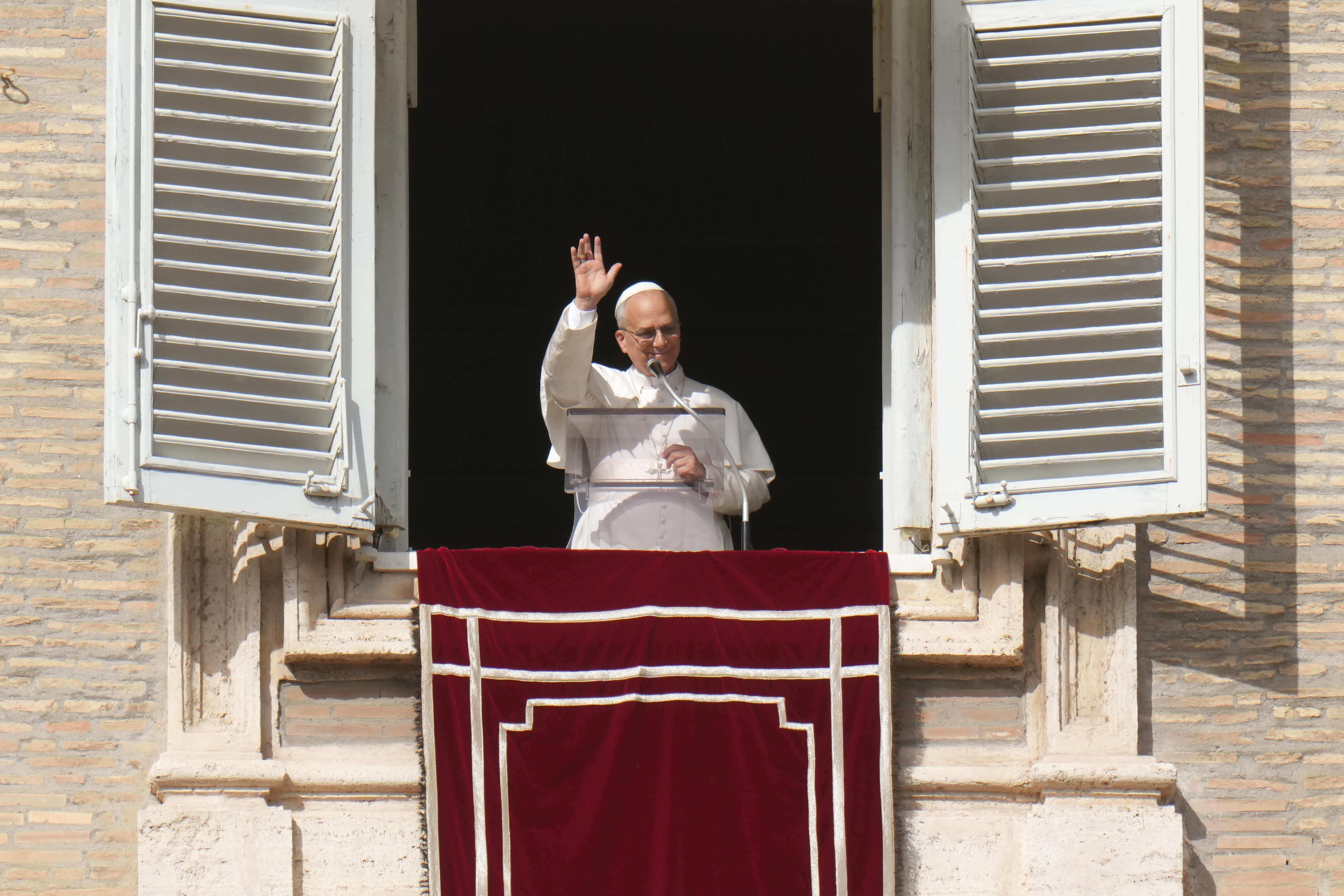 <p>Pope Leo XIV delivers his blessing as he recites the Angelus noon prayer from the window of his studio overlooking St.Peter's Square, at the Vatican</p>