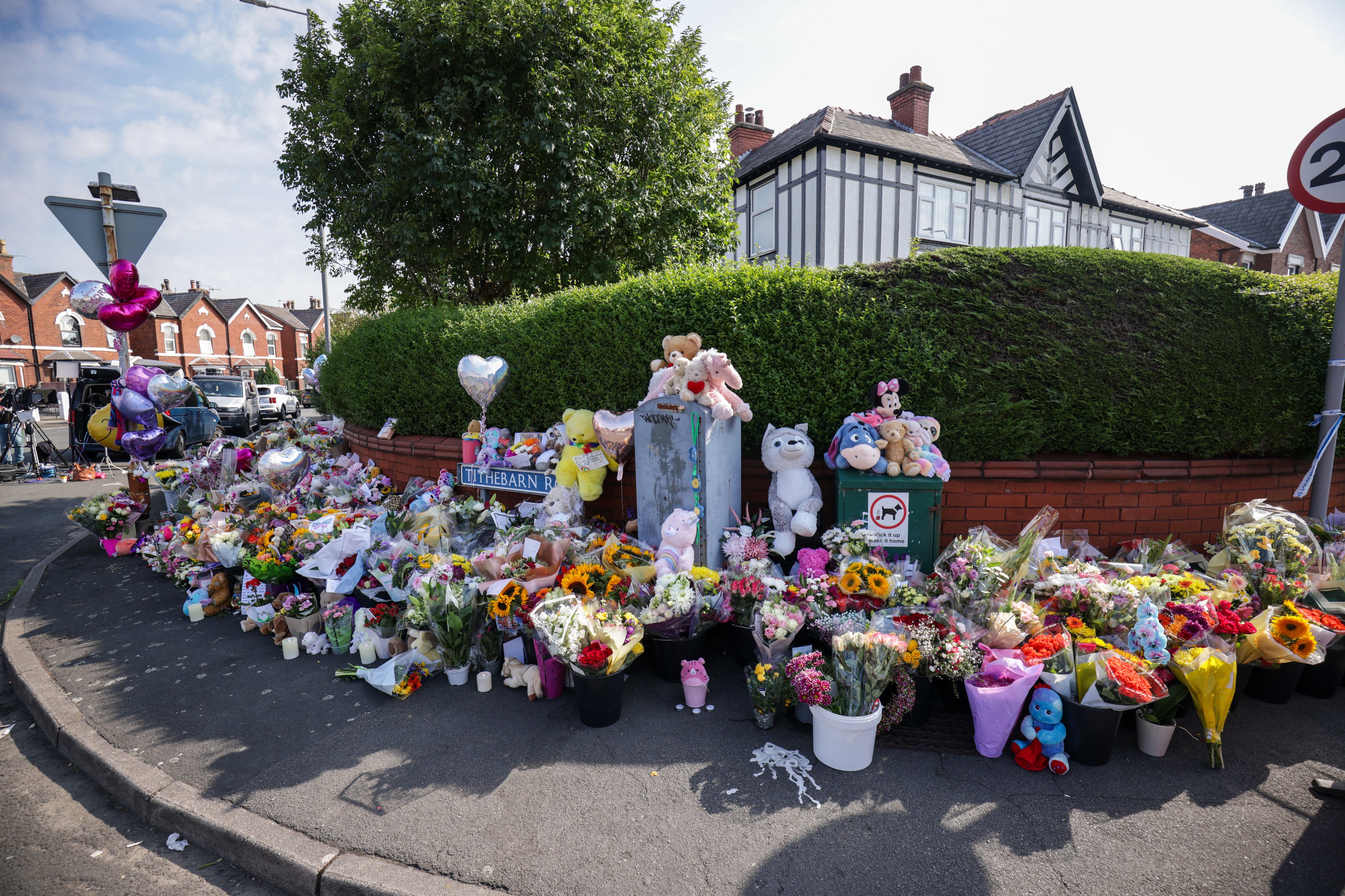 Floral tributes on the junction of Tithebarn Road and Hart Street in Southport (James Speakman/PA)