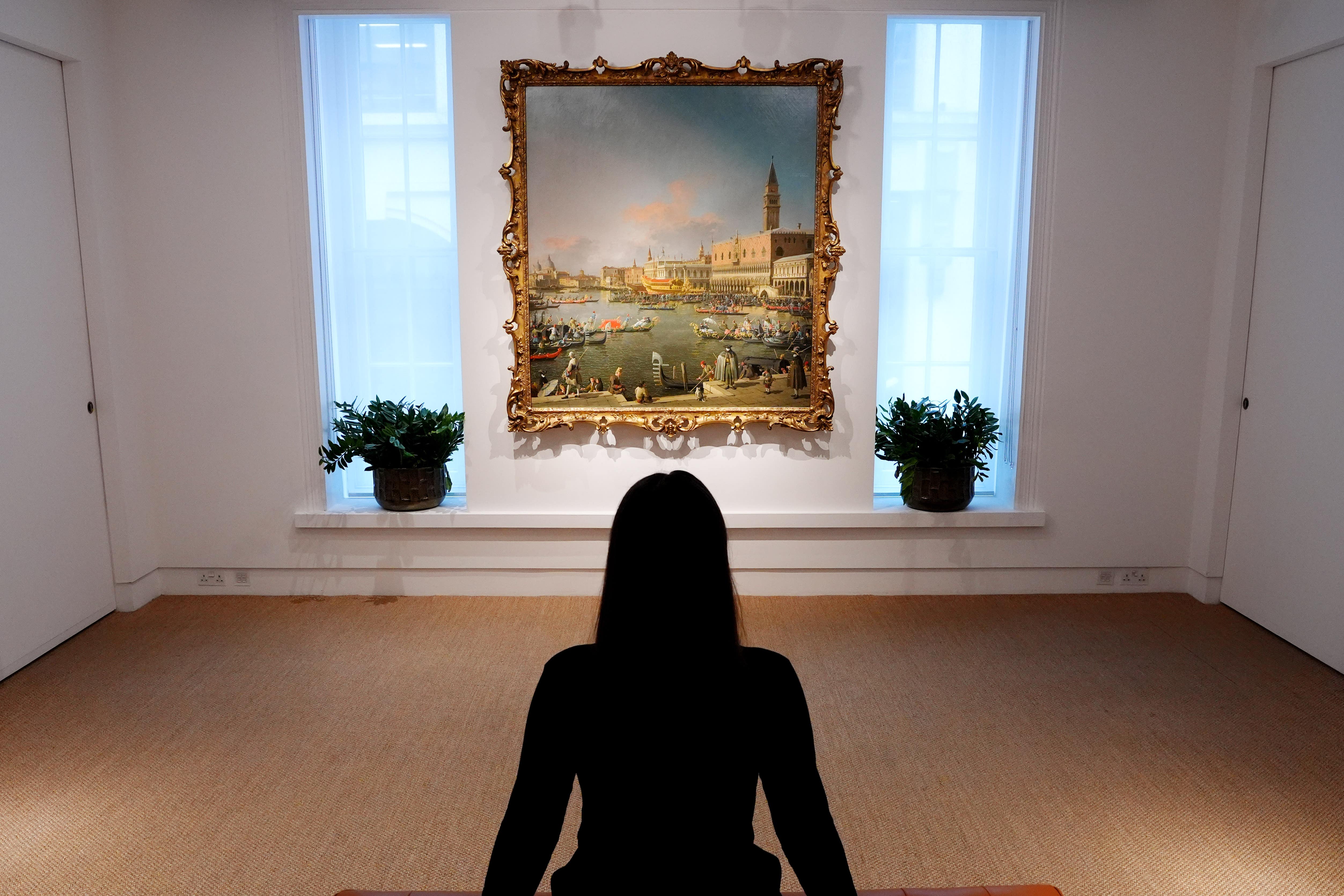 A member of staff look at Canaletto’s masterpiece Venice, the Bucintoro at the Molo on Ascension Day (Jonathan Brady/PA)