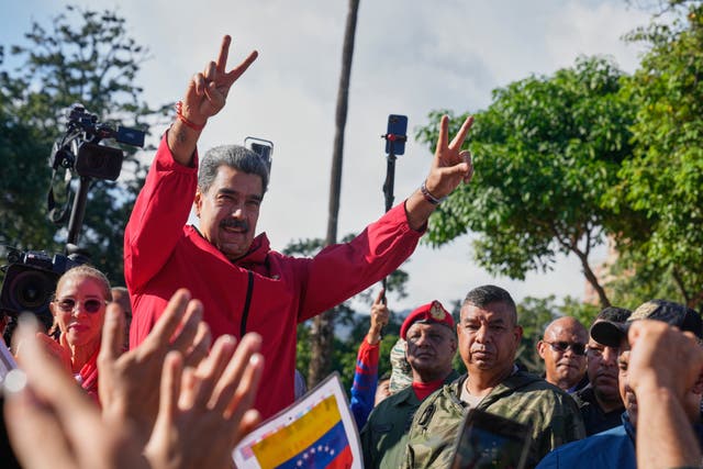 <p>President Nicolas Maduro flashes victory signs during Indigenous Day in Caracas, Venezuela, Oct 12, 2025</p>