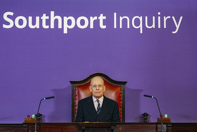 Chairman Sir Adrian Fulford sitting inside the hearing room at Liverpool Town Hall (Peter Byrne/PA)