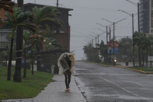 A man walks in Kingston, Jamaica, as Hurricane Melissa approaches (Matias Delacroix/AP photo)