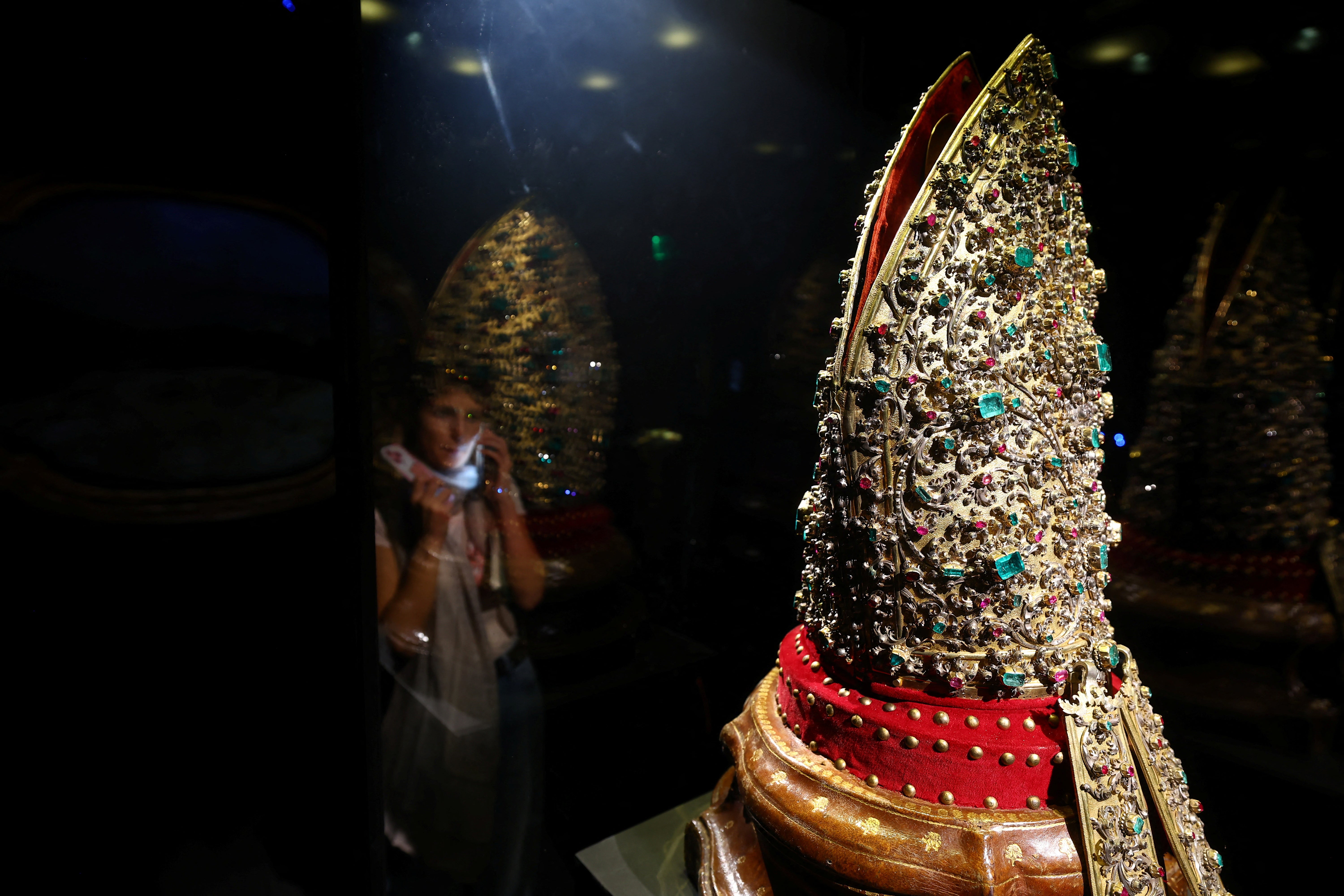 A visitor views a jewelled mitre encrusted with precious stones from the "Treasure of San Gennaro", one of the world's richest collections of sacred art, at the Museum of the Treasure of San Gennaro in Naples