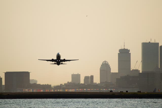 <p>Commercial airplanes taking off over the bay from Boston's airport</p>