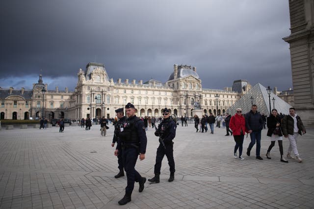 <p>Police officers patrol the exterior of the Louvre in Paris, France</p>