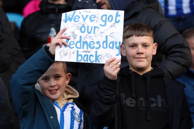 <p>Fans of Sheffield Wednesday show their support with a sign reading 'We've got our Wednesday back' </p>