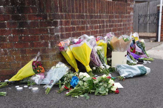 <p>Flowers left near the scene in Uxbridge </p>