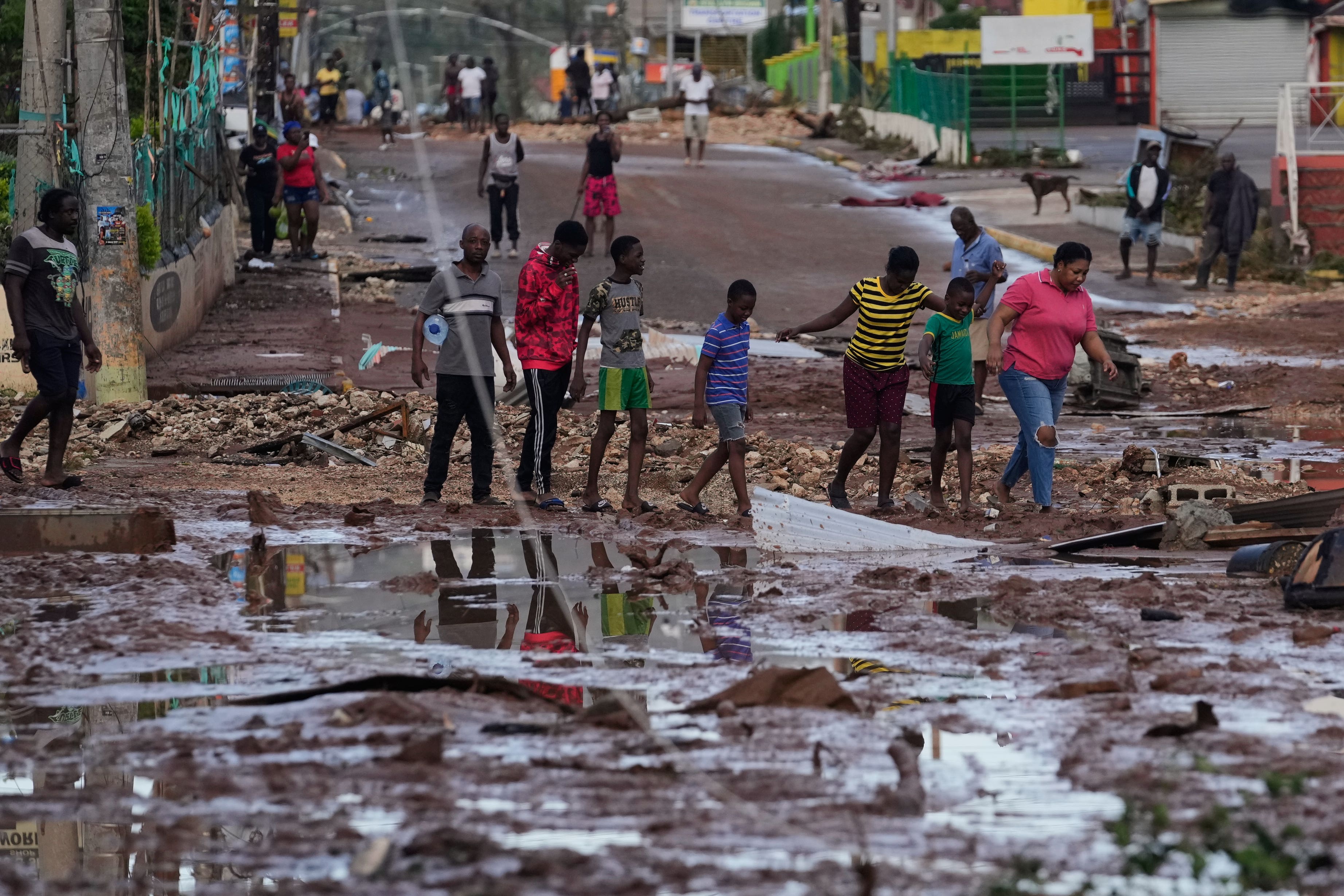 People walk through Santa Cruz, Jamaica (Matias Delacroix/AP)