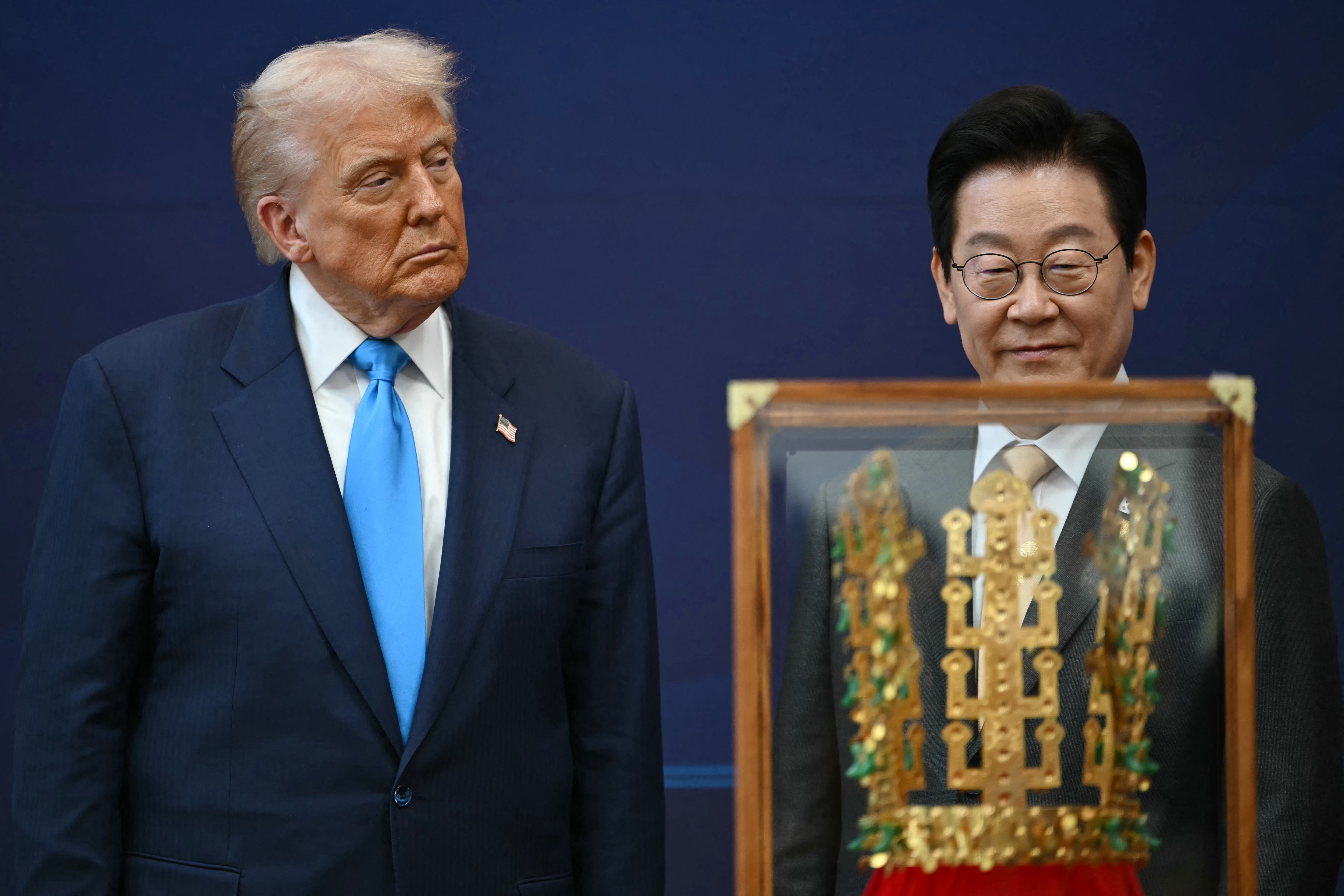 <p>President Donald Trump stands with South Korean President Lee Jae Myung during a high honor presentation ceremony, where Trump was presented with a replica of a crown worn by the kings of Silla</p>