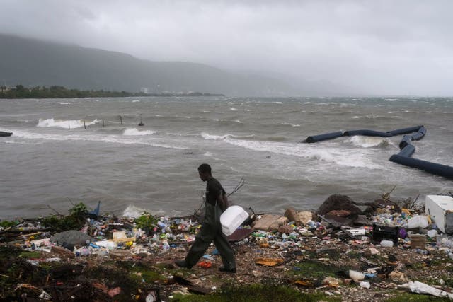 A man walks along the coastline during the passing of Hurricane Melissa in Kingston, Jamaica (Matias Delacroix/AP photo)